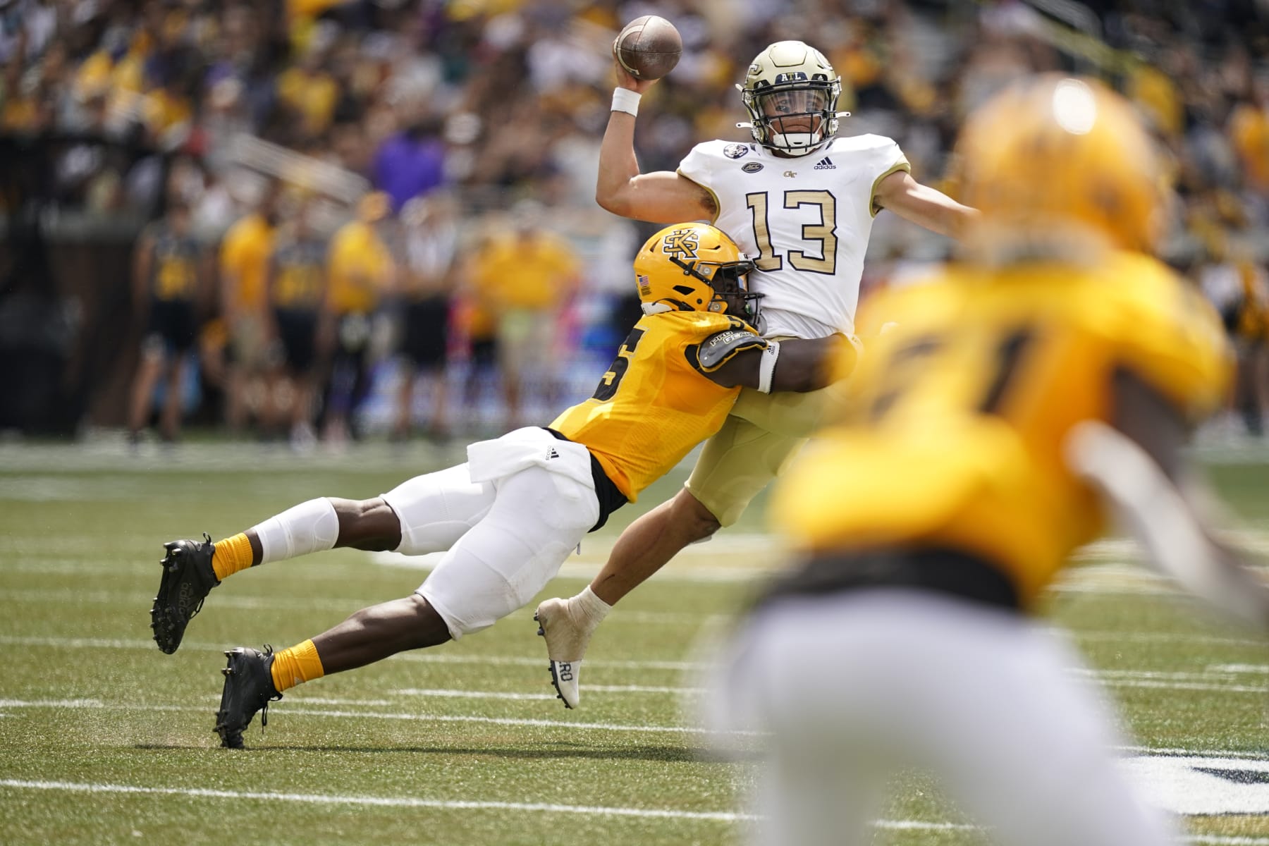 Kennesaw State defensive back Welton Spottsville (5) tackles Georgia Tech quarterback Jordan Yates (13) during an NCAA college football game, Saturday, Sept. 11, 2021, in Atlanta. (AP Photo/Brynn Anderson)