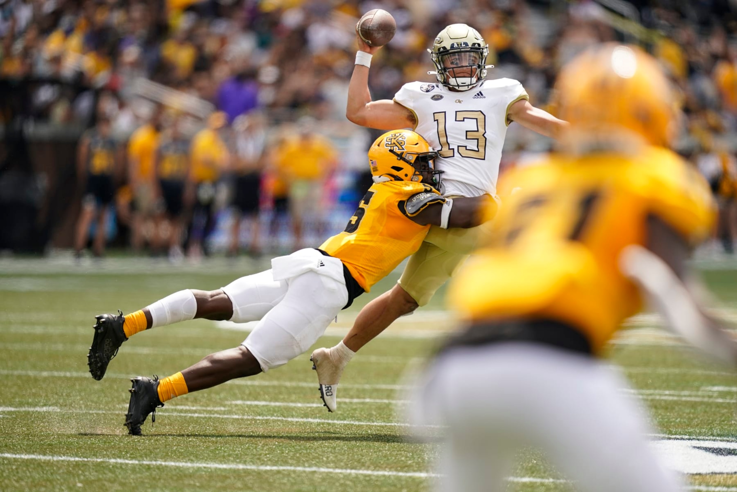 Kennesaw State defensive back Welton Spottsville (5) tackles Georgia Tech quarterback Jordan Yates (13) during an NCAA college football game, Saturday, Sept. 11, 2021, in Atlanta. (AP Photo/Brynn Anderson)