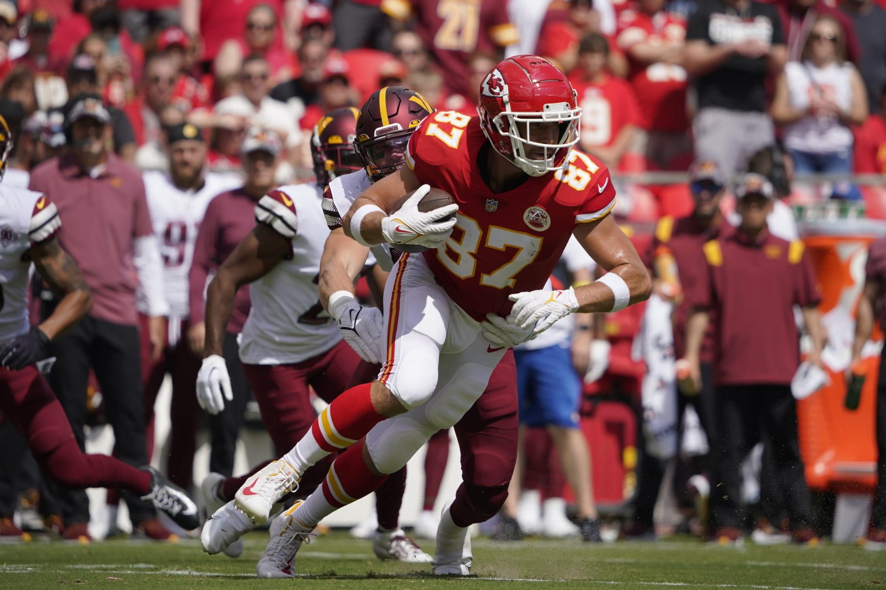 Kansas City Chiefs tight end Travis Kelce (87) gets past Washington Commanders linebacker Cole Holcomb (55) during a preseason NFL football game Saturday, Aug. 20, 2022, in Kansas City, Mo. (AP Photo/Ed Zurga)