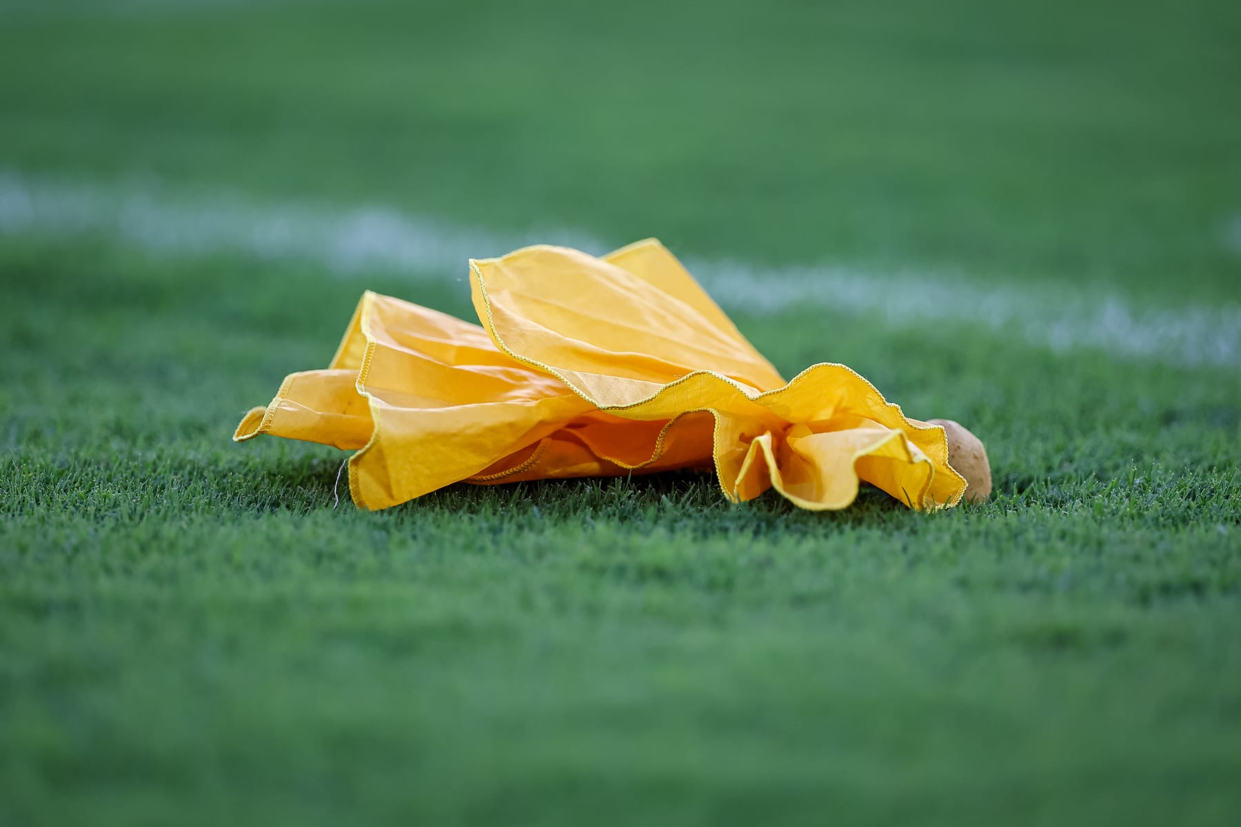 BALTIMORE, MD - AUGUST 11: A detailed view of a penalty flag on the field during the first half of the game between the Baltimore Ravens and the Tennessee Titans at M&T Bank Stadium on August 11, 2022 in Baltimore, Maryland. (Photo by Scott Taetsch/Getty Images)
