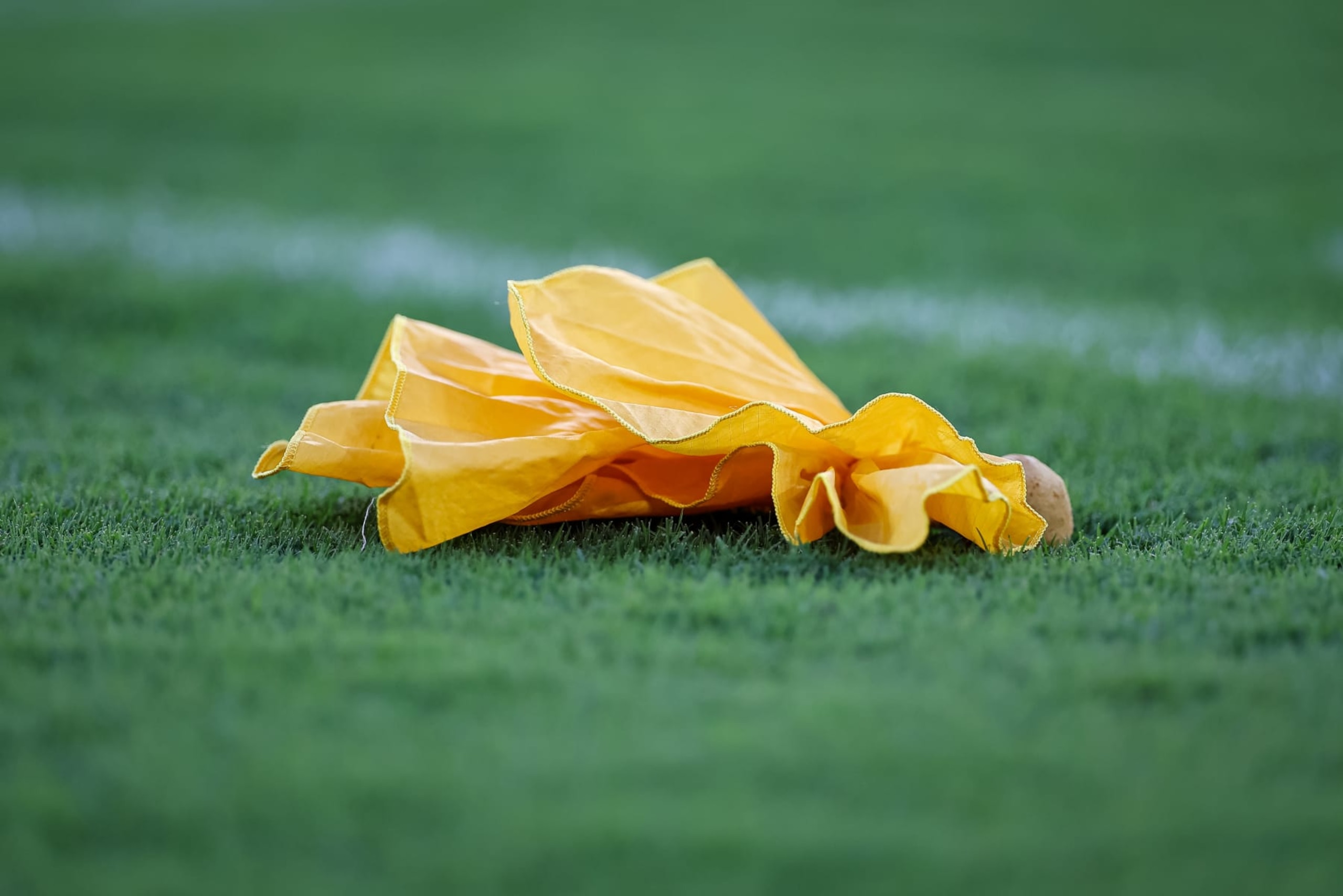BALTIMORE, MD - AUGUST 11: A detailed view of a penalty flag on the field during the first half of the game between the Baltimore Ravens and the Tennessee Titans at M&T Bank Stadium on August 11, 2022 in Baltimore, Maryland. (Photo by Scott Taetsch/Getty Images)