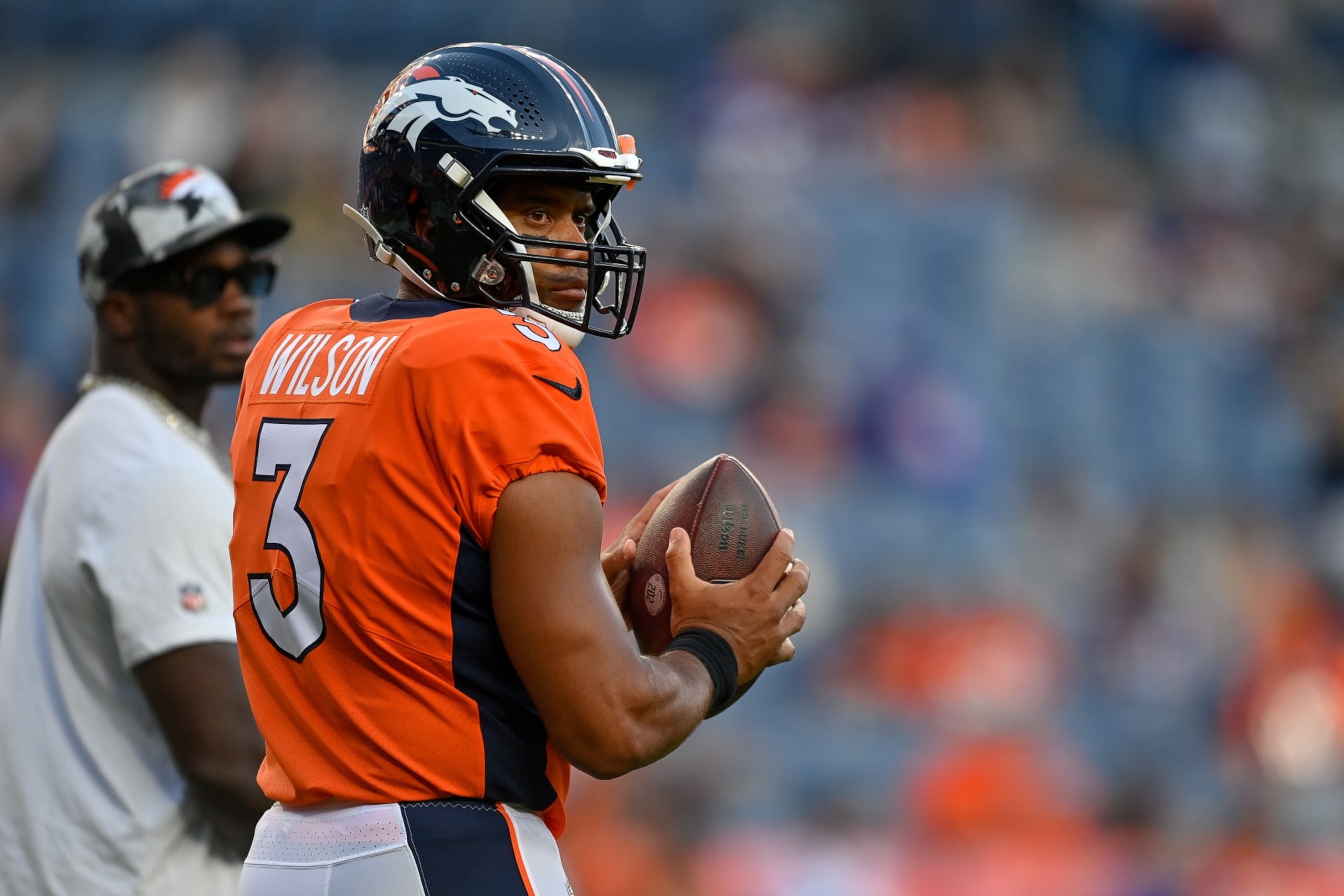 DENVER, COLORADO - AUGUST 27: Quarterback Russell Wilson #3 of the Denver Broncos warms up before a preseason game against the Minnesota Vikings at Empower Field at Mile High on August 27, 2022 in Denver, Colorado. (Photo by Dustin Bradford/Getty Images)