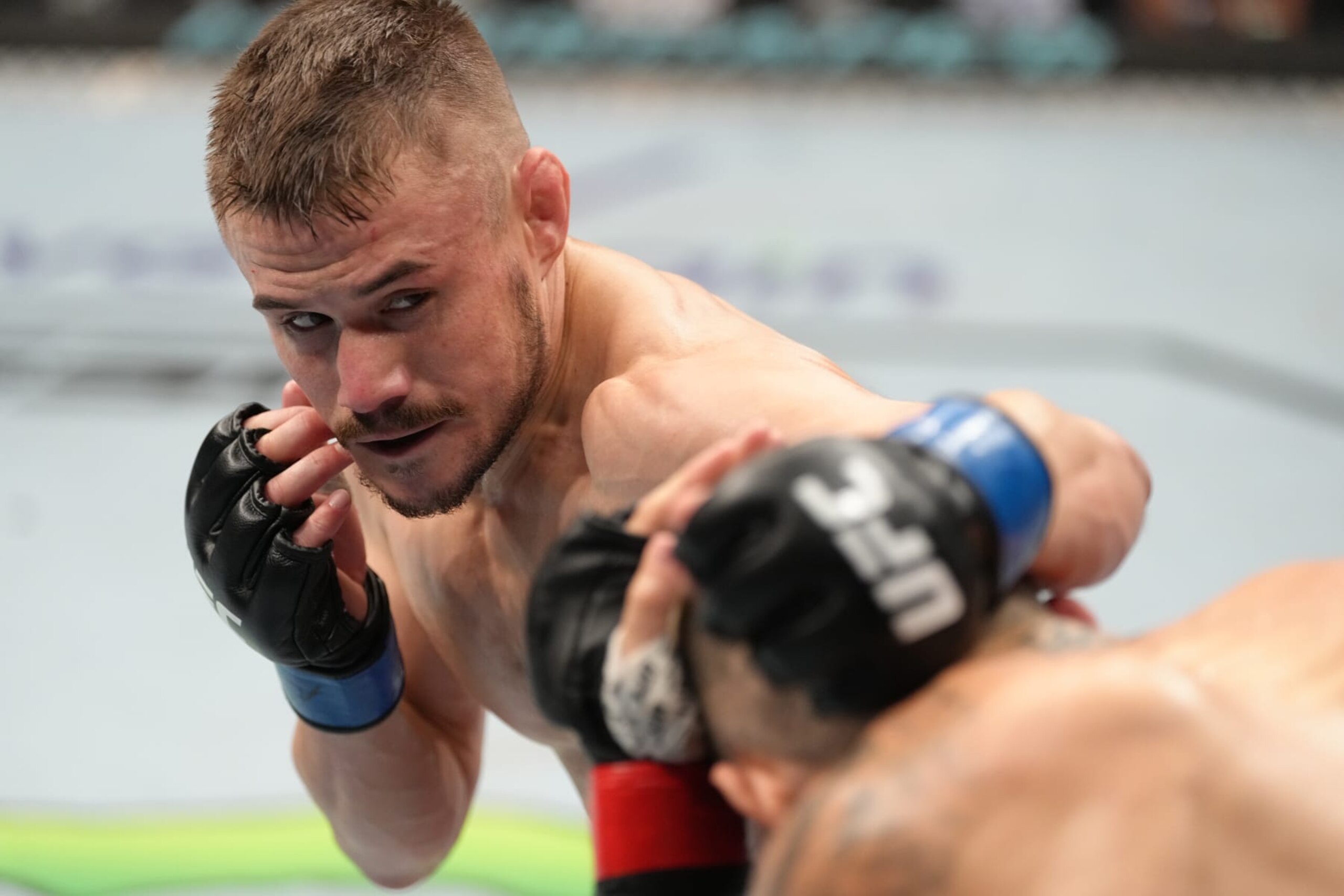 PARIS, FRANCE - SEPTEMBER 03: (L-R) Nathaniel Wood of England punches Charles Jourdain of Canada in a featherweight fight during the UFC Fight Night event at The Accor Arena on September 03, 2022 in Paris, France. (Photo by Jeff Bottari/Zuffa LLC)