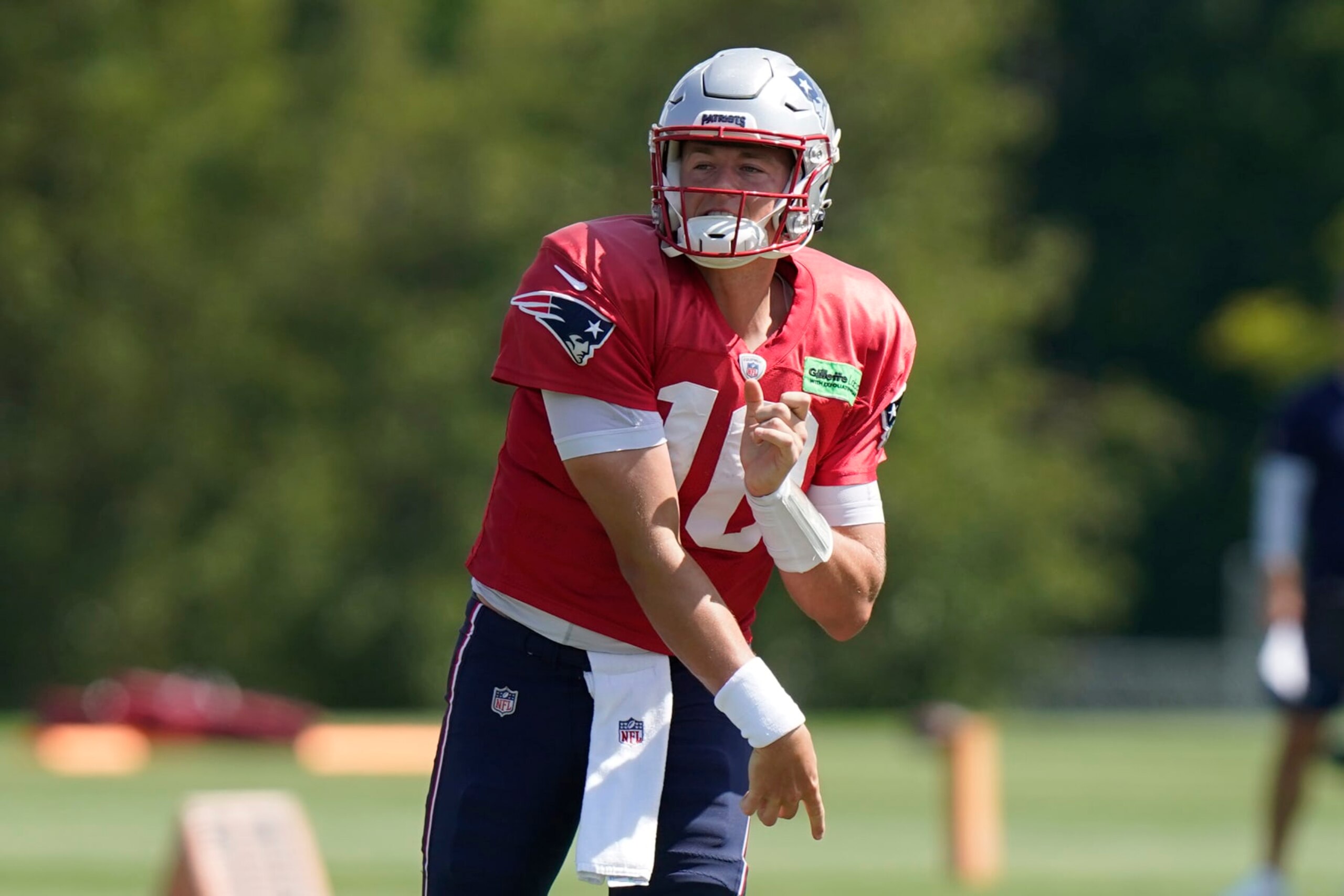 New England Patriots quarterback Mac Jones (10) follows through on a pass during an NFL football practice, Wednesday, Aug. 31, 2022, in Foxborough, Mass. (AP Photo/Steven Senne)