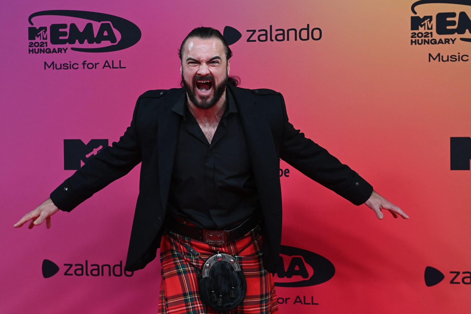 Scottish professional wrestler Drew McIntyre poses on the red carpet as he arrives for the MTV Europe Music Awards at the Laszlo Papp Budapest Sports Arena in Budapest, Hungary on November 14, 2021. (Photo by Attila KISBENEDEK / AFP) (Photo by ATTILA KISBENEDEK/AFP via Getty Images)