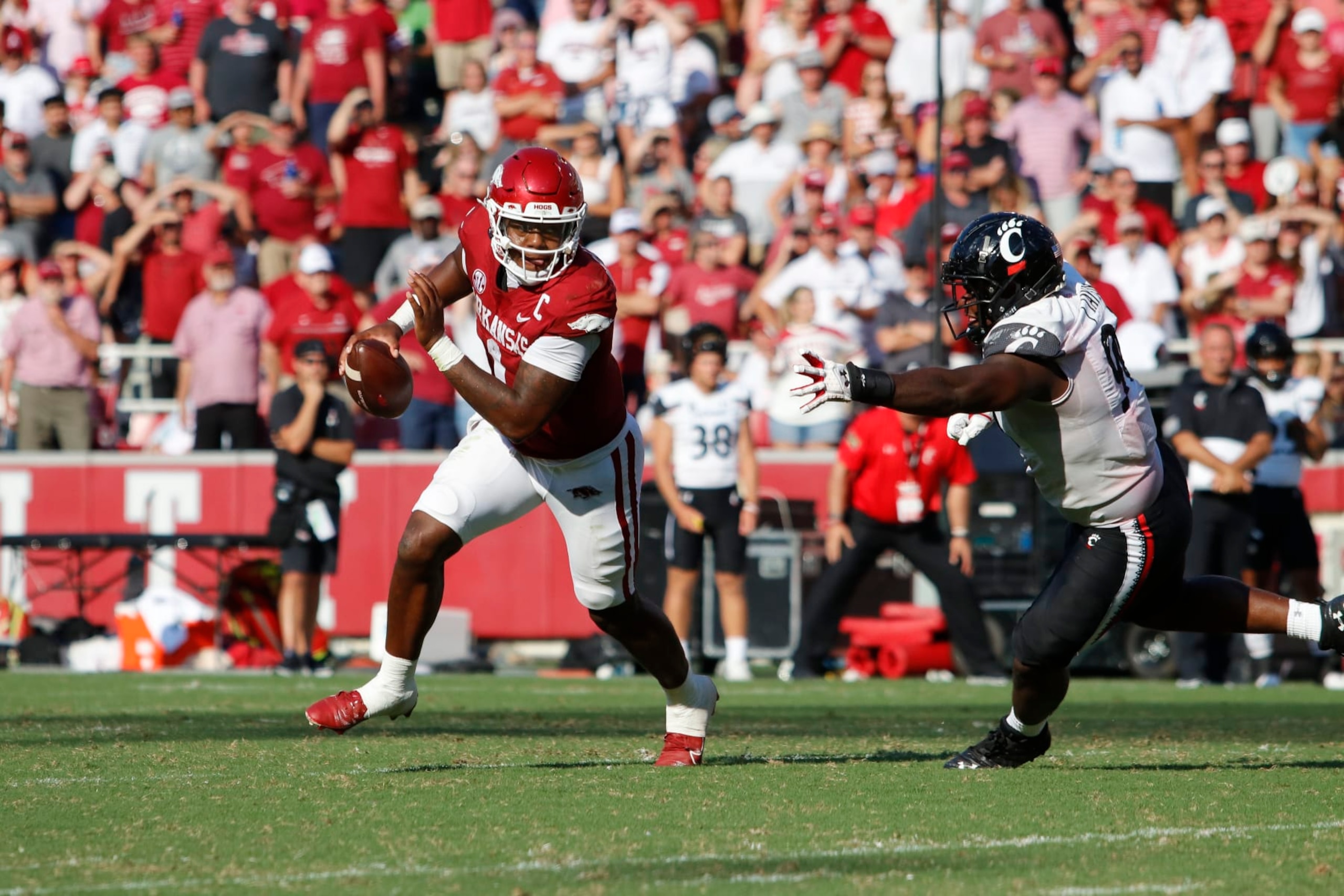 FAYETTEVILLE, AR - SEPTEMBER 03: Arkansas Razorbacks quarterback KJ Jefferson (1) scrambles past Cincinnati Bearcats defensive lineman Jabari Taylor (90) during the college football game between the Cincinnati Bearcats and Arkansas Razorbacks on September 3, 2022, at Donald W. Reynolds Razorback Stadium in Fayetteville, Arkansas.  (Photo by Andy Altenburger/Icon Sportswire via Getty Images)