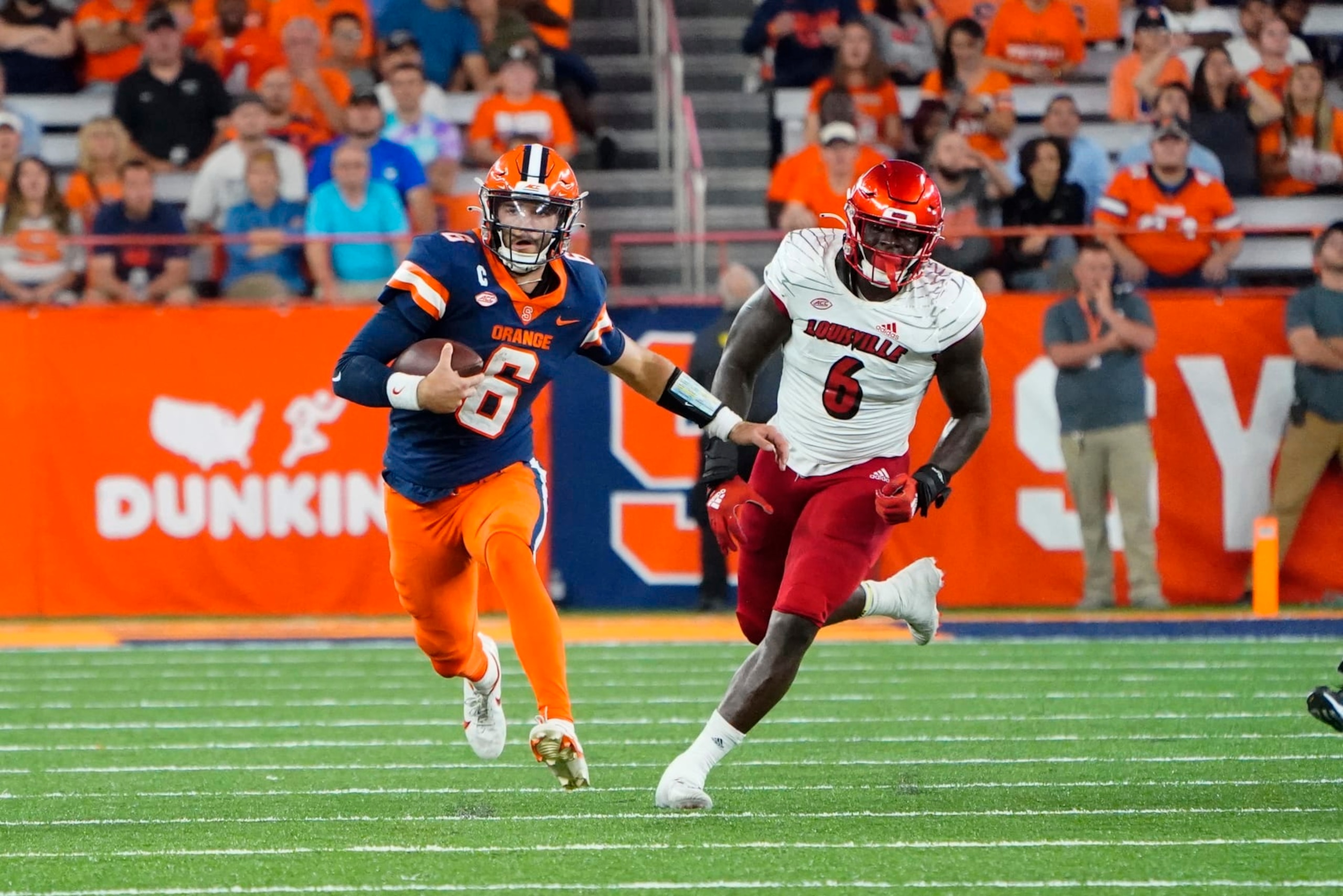 SYRACUSE, NY - SEPTEMBER 03: Syracuse Orange Quarterback Garrett Shrader (6) runs with the ball with Louisville Cardinals Defensive Lineman YaYa Diaby (6) in pursuit during the first half of the college football game between the Louisville Cardinals and the Syracuse Orange on September 3, 2022, at the JMA Wireless Dome in Syracuse, New York. (Photo by Gregory Fisher/Icon Sportswire via Getty Images)