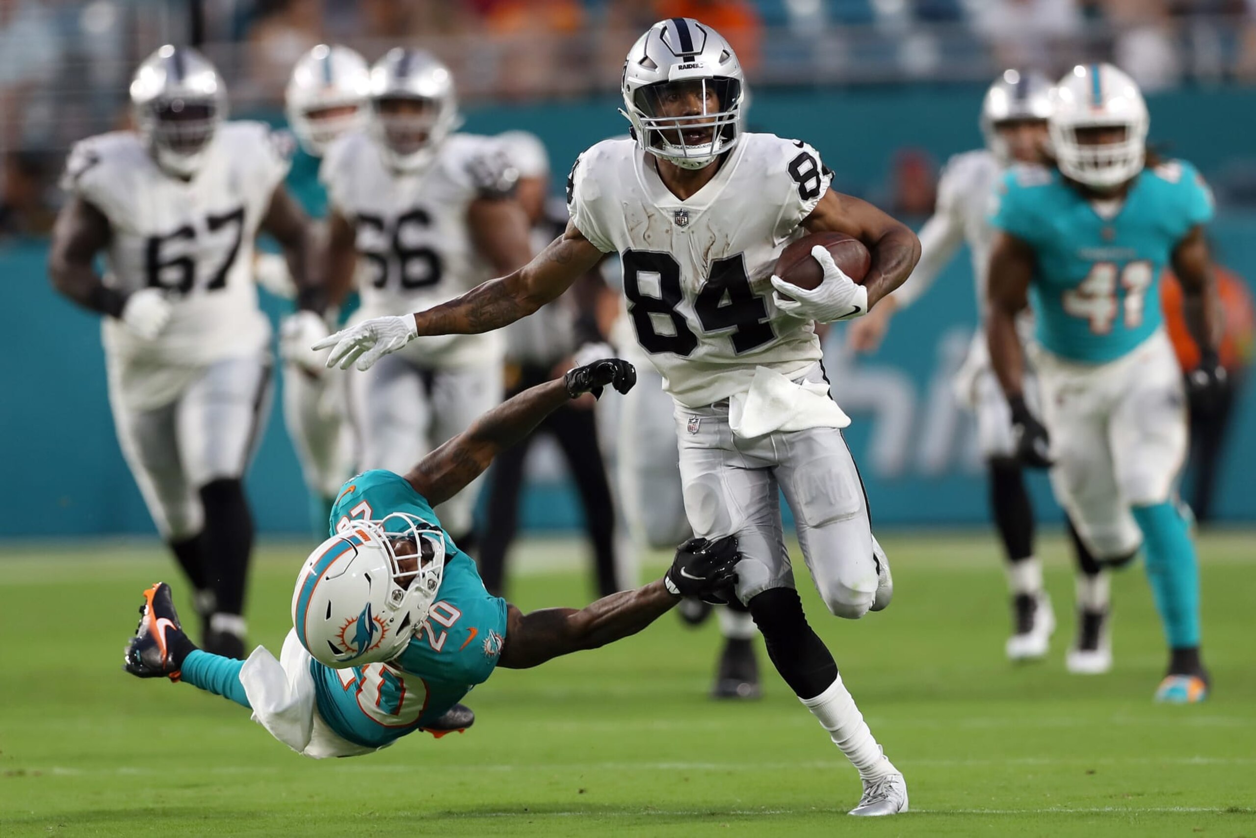 MIAMI GARDENS, FLORIDA - AUGUST 20: Keelan Cole #84 of the Las Vegas Raiders runs against Sheldrick Redwine #20 of the Miami Dolphins during the second quarter at Hard Rock Stadium on August 20, 2022 in Miami Gardens, Florida. (Photo by Megan Briggs/Getty Images)
