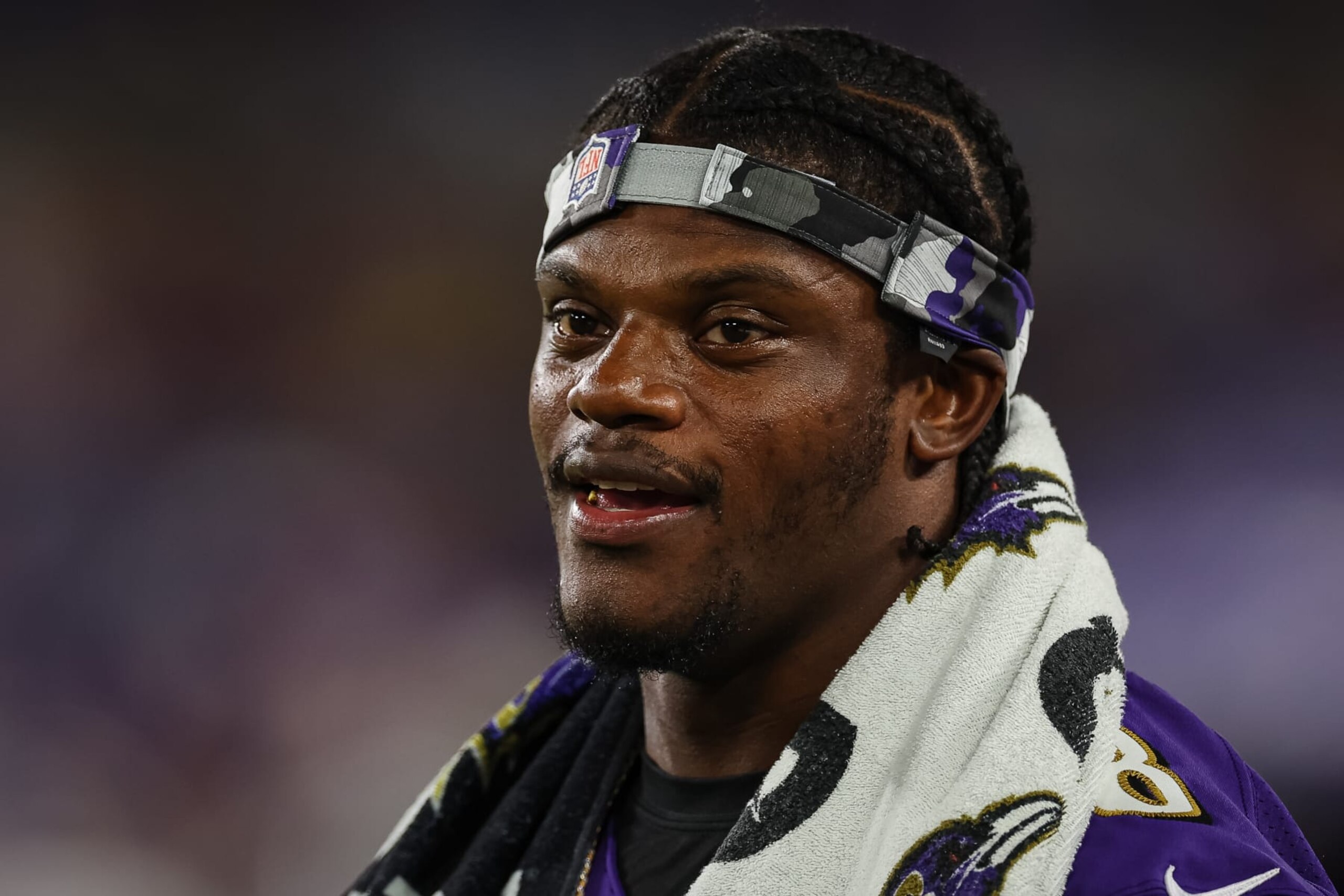BALTIMORE, MD - AUGUST 11: Lamar Jackson #8 of the Baltimore Ravens looks on from the sidelines during the second half against the Tennessee Titans at M&T Bank Stadium on August 11, 2022 in Baltimore, Maryland. (Photo by Scott Taetsch/Getty Images)