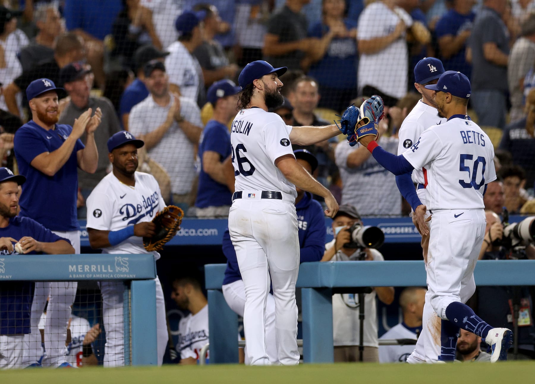 LOS ANGELES, CALIFORNIA - AUGUST 23: Tony Gonsolin #26 of the Los Angeles Dodgers celebrates the catch of Mookie Betts #50, for an out of Luis Urias #2 of the Milwaukee Brewers to end the second inning at Dodger Stadium on August 23, 2022 in Los Angeles, California. (Photo by Harry How/Getty Images)
