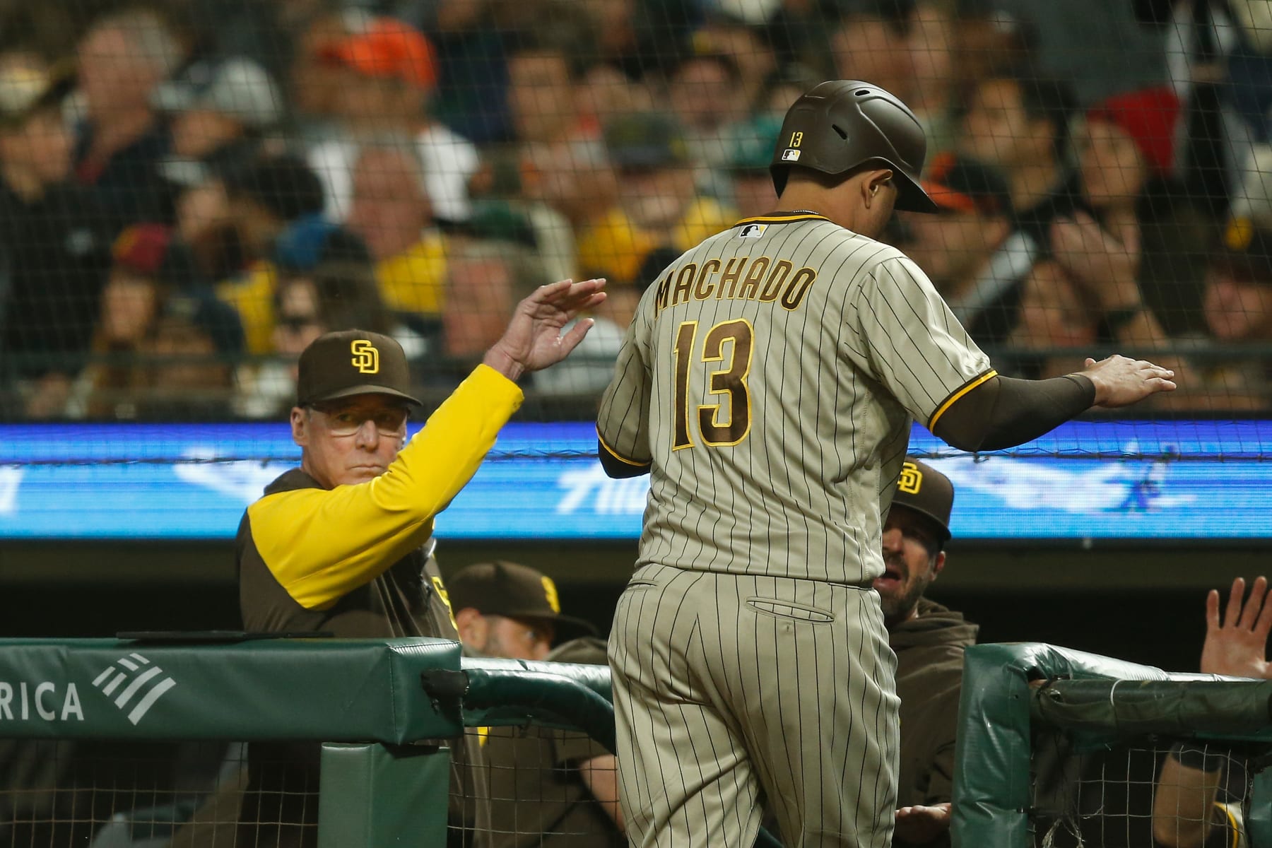 SAN FRANCISCO, CALIFORNIA - AUGUST 30: Manny Machado #13 of the San Diego Padres celebrates with manager Bob Melvin #3 after scoring on a single by Josh Bell #24 in the top of the sixth inning against the San Francisco Giants at Oracle Park on August 30, 2022 in San Francisco, California. (Photo by Lachlan Cunningham/Getty Images)