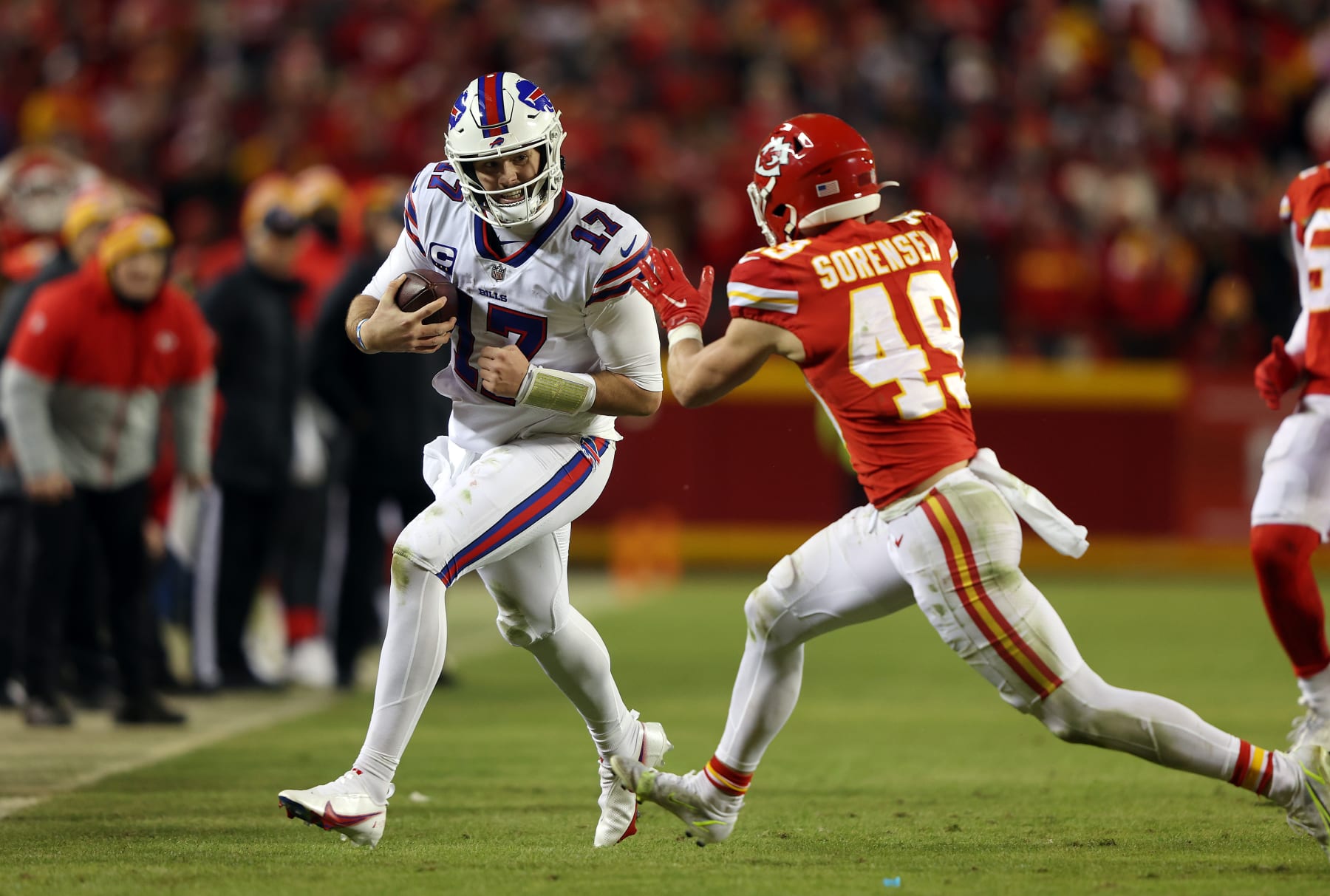 KANSAS CITY, MISSOURI - JANUARY 23:  Quarterback Josh Allen #17 of the Buffalo Bills scrambles as safety Daniel Sorensen #49 of the Kansas City Chiefs defends during the 4th quarter of the AFC Divisional Playoff game at Arrowhead Stadium on January 23, 2022 in Kansas City, Missouri. (Photo by Jamie Squire/Getty Images)