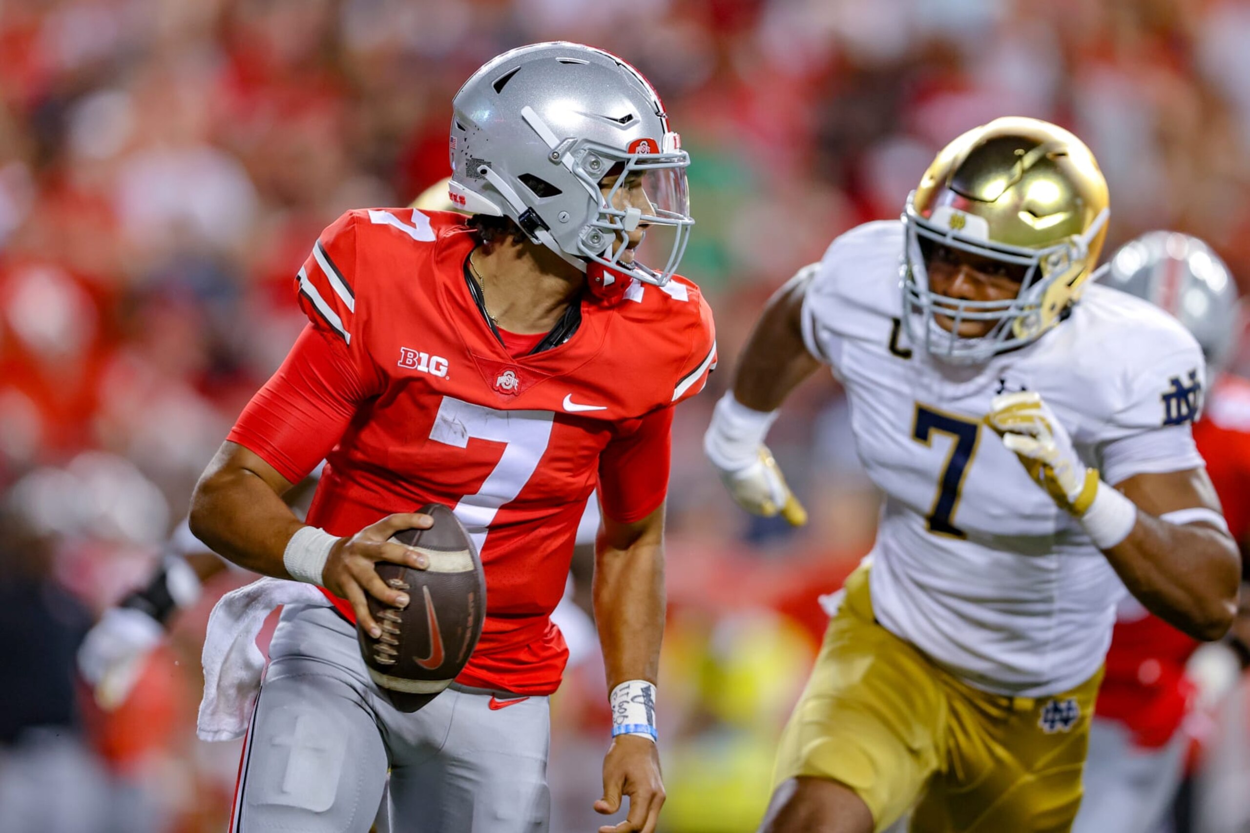 COLUMBUS, OH - SEPTEMBER 03: Ohio State Buckeyes quarterback C.J. Stroud (7) rolls out of the pocket as Notre Dame Fighting Irish defensive lineman Isaiah Foskey (7) applies pressure during the third quarter of the college football game between the Notre Dame Fighting Irish and Ohio State Buckeyes on September 3, 2022, at Ohio Stadium in Columbus, OH. (Photo by Frank Jansky/Icon Sportswire via Getty Images)