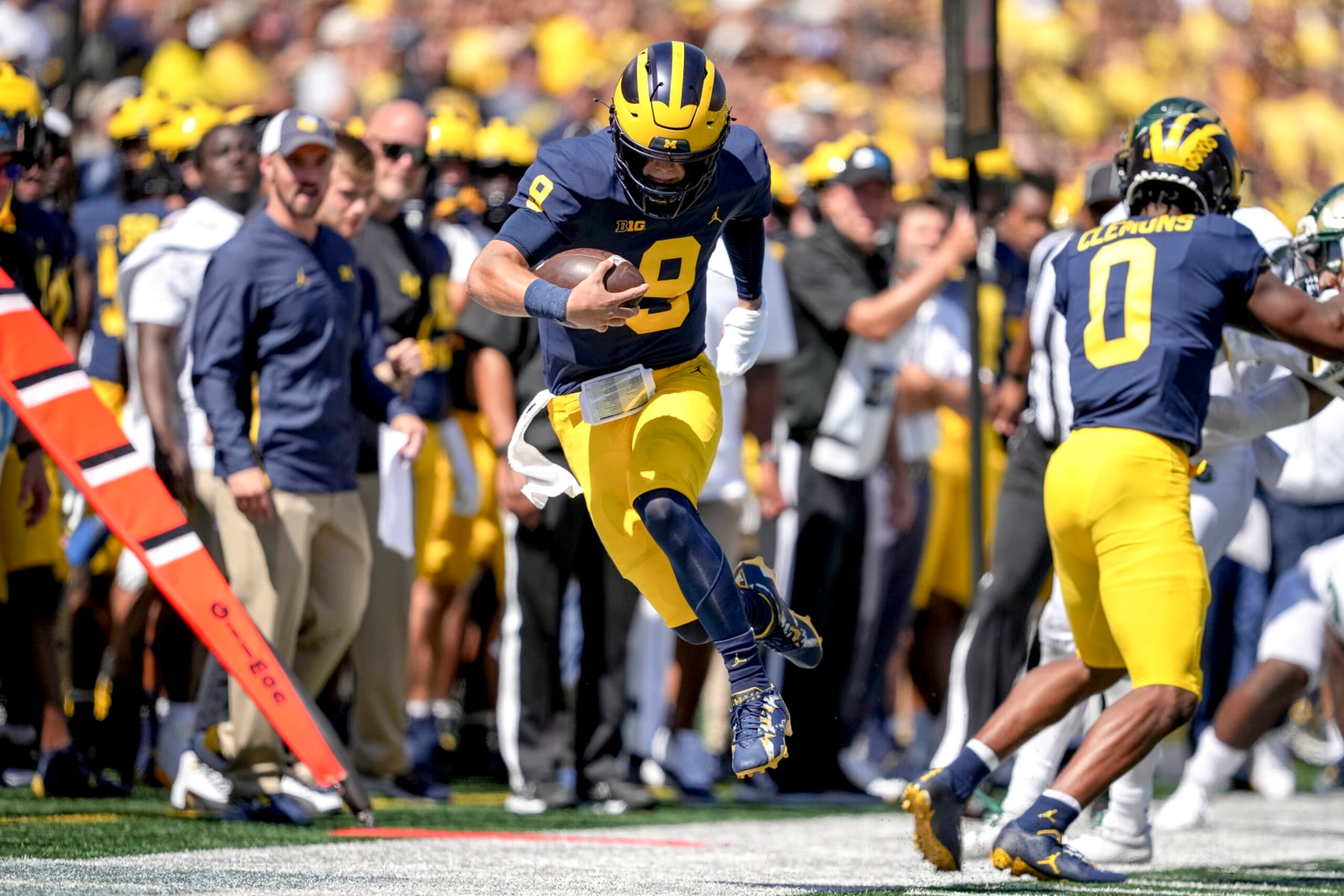 ANN ARBOR, MICHIGAN - SEPTEMBER 03: J.J. McCarthy #9 of the Michigan Wolverines is forced out of bounds against the Colorado State Rams during the second half at Michigan Stadium on September 03, 2022 in Ann Arbor, Michigan. (Photo by Nic Antaya/Getty Images)