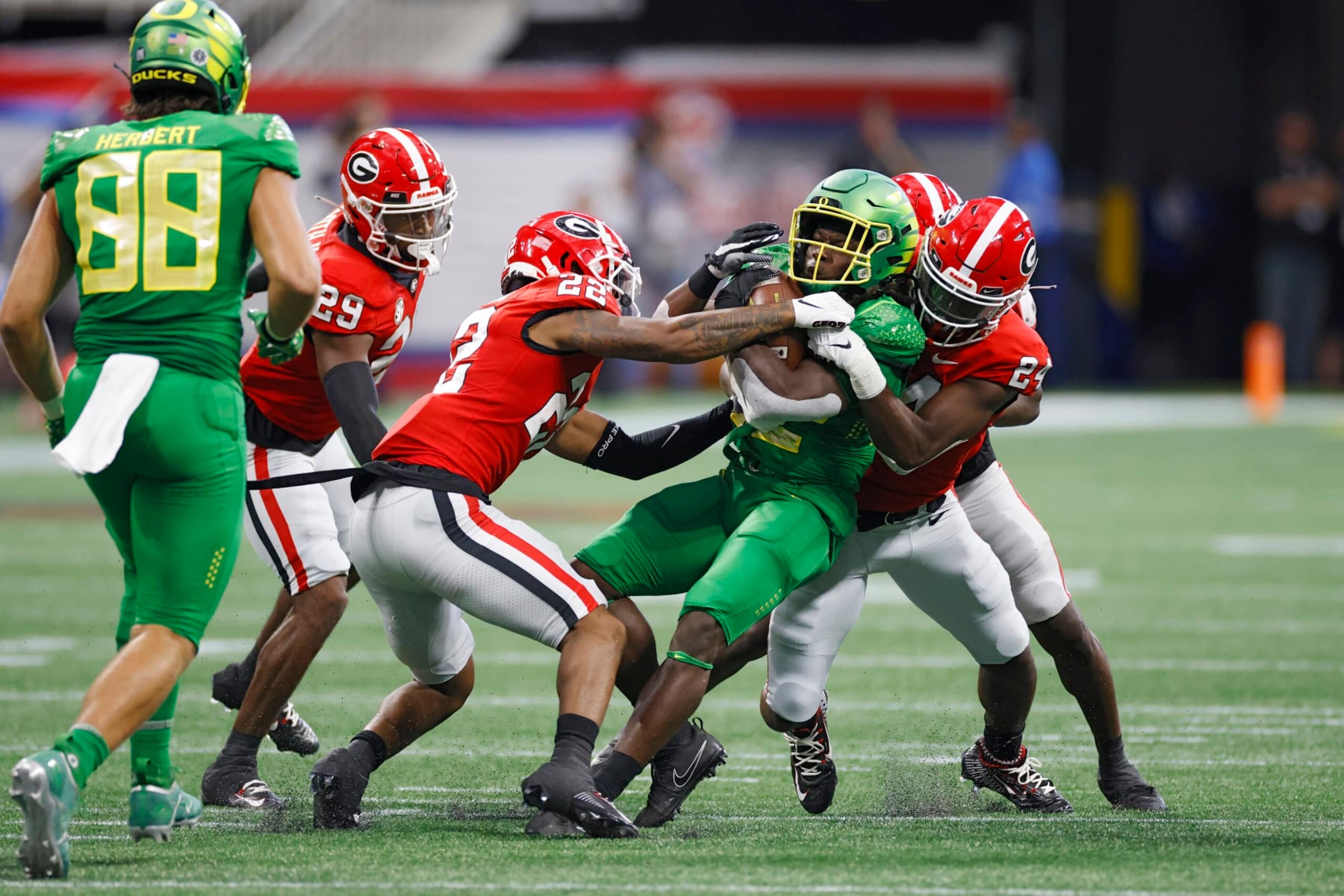 ATLANTA, GA - SEPTEMBER 03: Georgia Bulldogs defensive back Javon Bullard (22) and defensive back Malaki Starks (24) tackle Oregon Ducks running back Noah Whittington (22) during the Chick-Fil-A Kickoff Game on September 4, 2022 at Mercedes-Benz Stadium in Atlanta, Georgia. (Photo by Joe Robbins/Icon Sportswire via Getty Images)