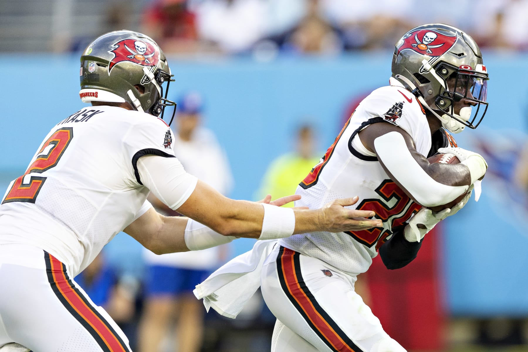 NASHVILLE, TENNESSEE - AUGUST 20: Kyle Trask #2 hands off the ball to Rachaad White #29 of the Tampa Bay Buccaneers during a preseason game against the Tennessee Titans at Nissan Stadium on August 20, 2022 in Nashville, Tennessee. (Photo by Wesley Hitt/Getty Images)