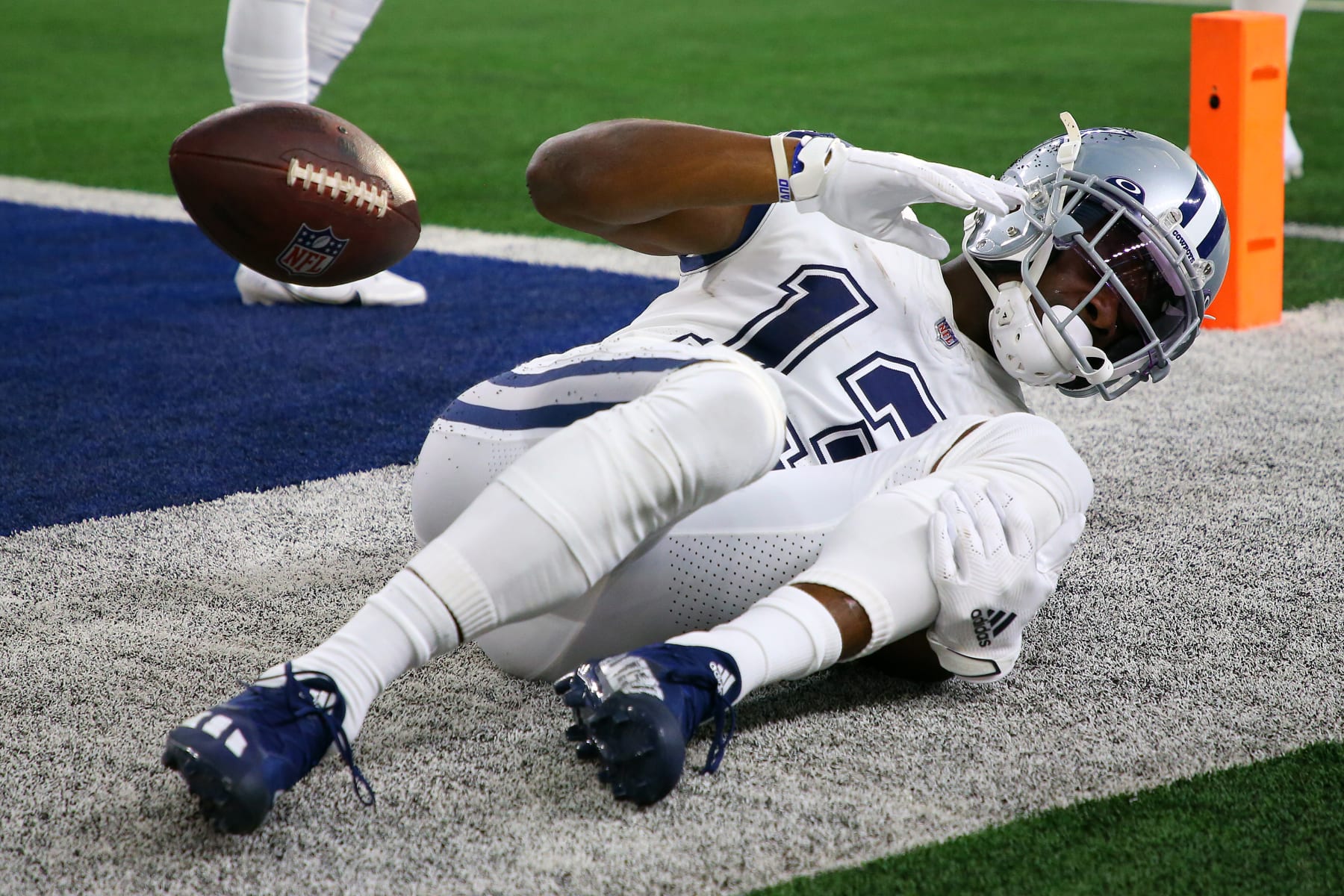 ARLINGTON, TEXAS - JANUARY 02: Michael Gallup #13 of the Dallas Cowboys holds his leg after catching the ball for a touchdown during the second quarter against the Arizona Cardinals at AT&T Stadium on January 02, 2022 in Arlington, Texas. (Photo by Richard Rodriguez/Getty Images)
