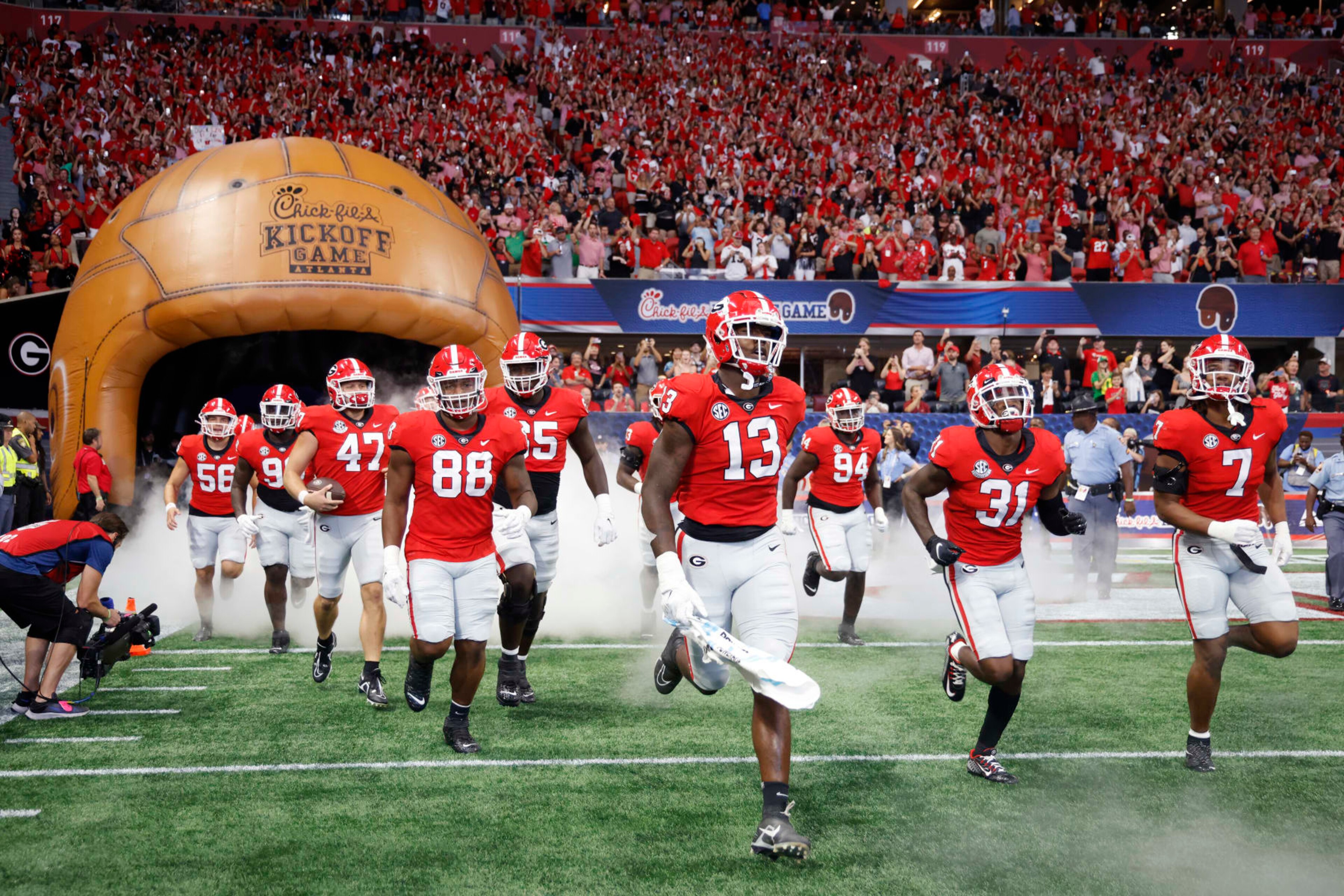 ATLANTA, GA - SEPTEMBER 03: Georgia Bulldogs players run onto the field prior to the Chick-Fil-A Kickoff Game against the Oregon Ducks on September 4, 2022 at Mercedes-Benz Stadium in Atlanta, Georgia. (Photo by Joe Robbins/Icon Sportswire via Getty Images) ATLANTA, GA - SEPTEMBER 03: Georgia Bulldogs players run onto the field prior to the Chick-Fil-A Kickoff Game against the Oregon Ducks on September 4, 2022 at Mercedes-Benz Stadium in Atlanta, Georgia. (Photo by Joe Robbins/Icon Sportswire via Getty Images)