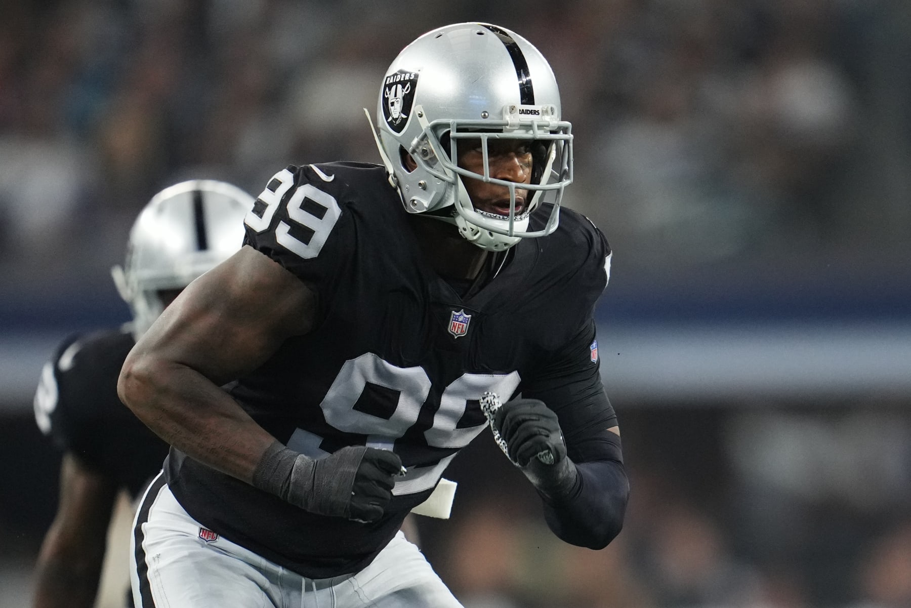 ARLINGTON, TEXAS - NOVEMBER 25: Clelin Ferrell #99 of the Las Vegas Raiders defends against the Dallas Cowboys during an NFL game at AT&T Stadium on November 25, 2021 in Arlington, Texas. (Photo by Cooper Neill/Getty Images)
