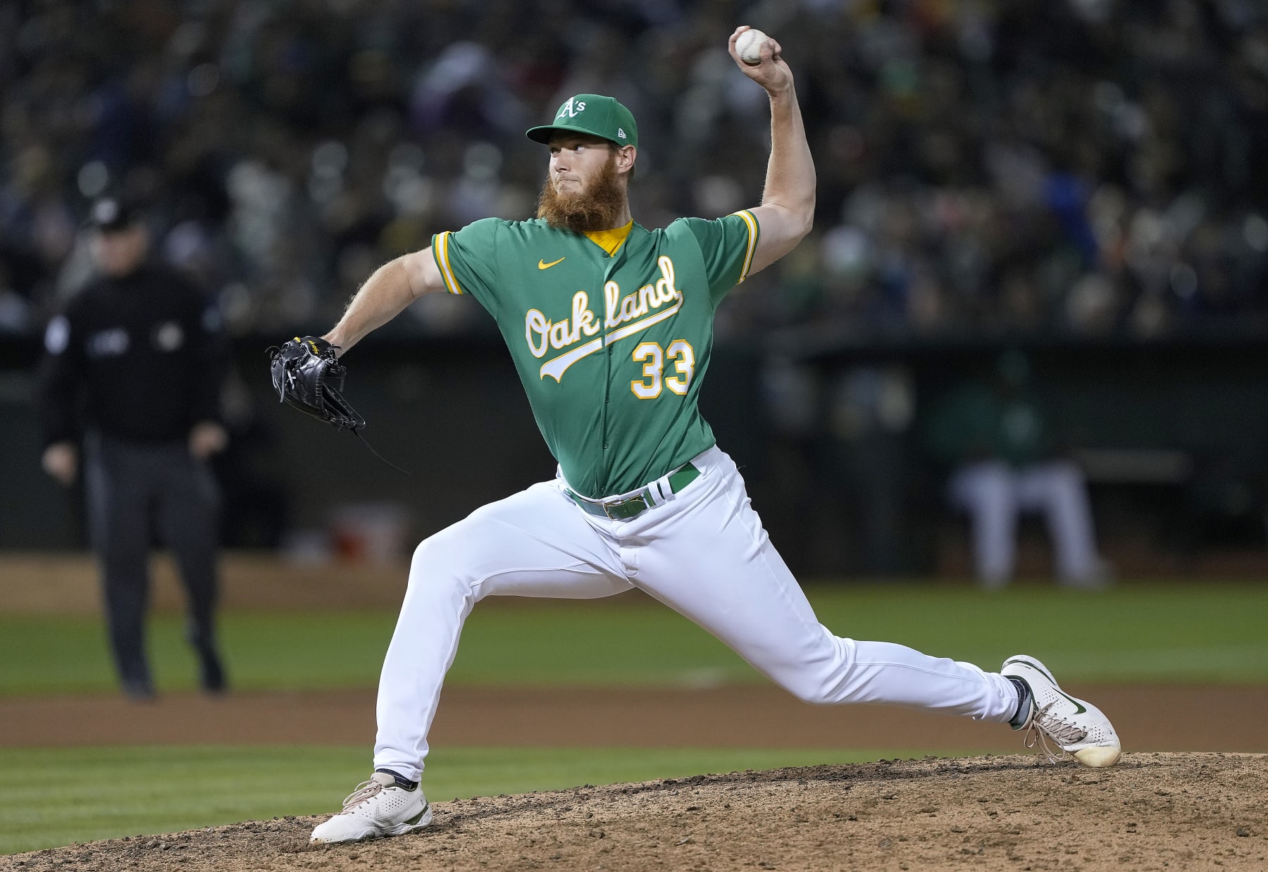 OAKLAND, CALIFORNIA - AUGUST 27: A.J. Puk #33 of the Oakland Athletics pitches against the New York Yankees in the top of the 10th inning at RingCentral Coliseum on August 27, 2022 in Oakland, California. (Photo by Thearon W. Henderson/Getty Images)