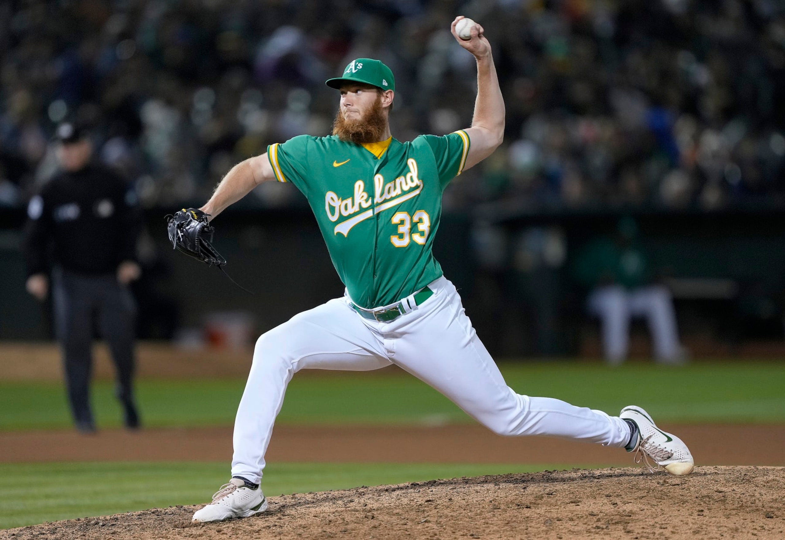 OAKLAND, CALIFORNIA - AUGUST 27: A.J. Puk #33 of the Oakland Athletics pitches against the New York Yankees in the top of the 10th inning at RingCentral Coliseum on August 27, 2022 in Oakland, California. (Photo by Thearon W. Henderson/Getty Images)