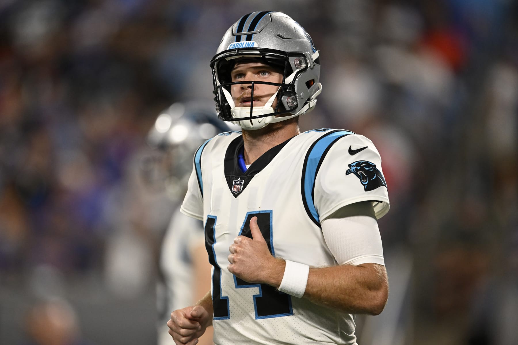 CHARLOTTE, NORTH CAROLINA - AUGUST 26: Sam Darnold #14 of the Carolina Panthers runs off the field after a play against the Buffalo Bills in the second quarter of a preseason game at Bank of America Stadium on August 26, 2022 in Charlotte, North Carolina. (Photo by Eakin Howard/Getty Images)