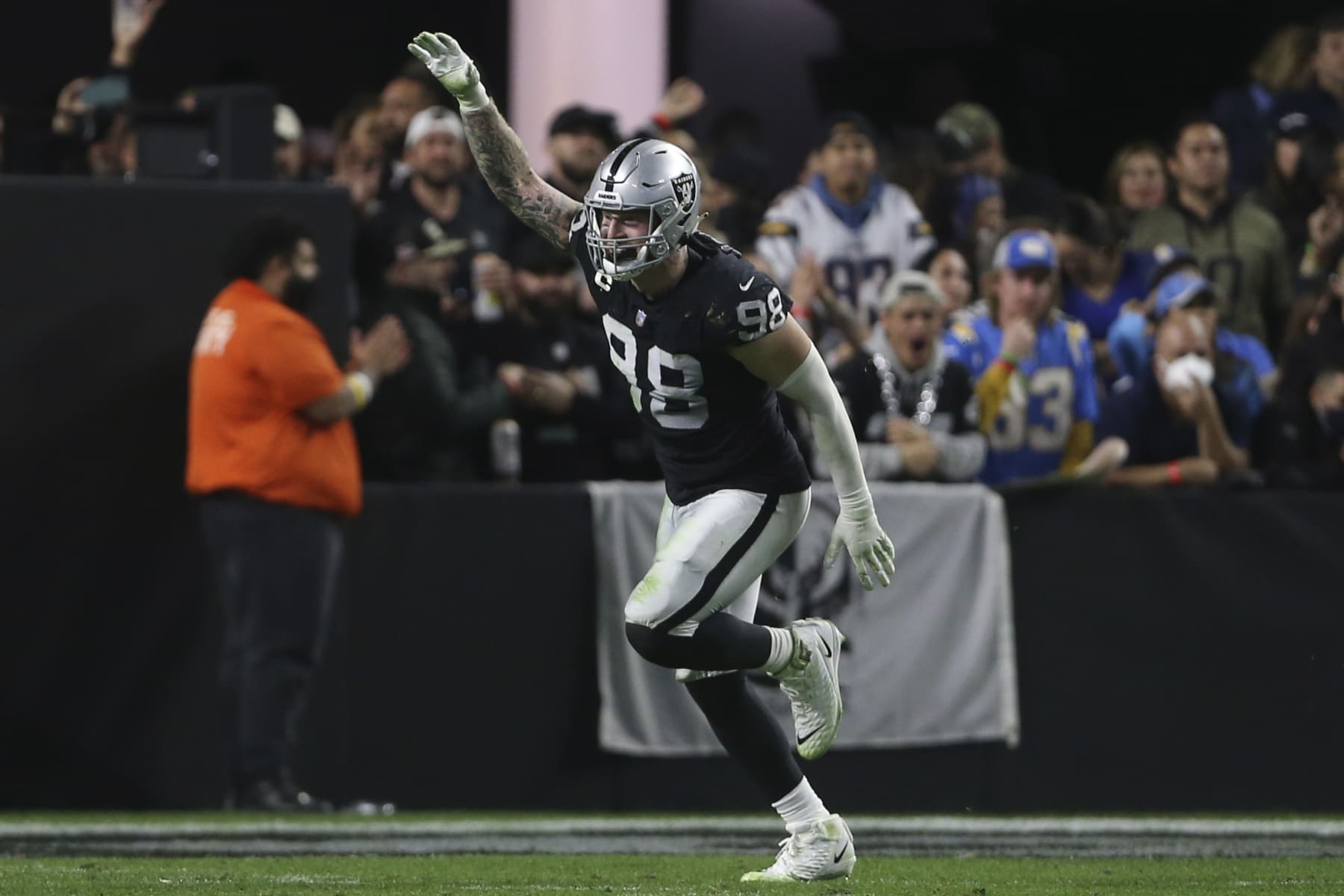 Las Vegas Raiders defensive end Maxx Crosby (98) celebrates after sacking Los Angeles Chargers quarterback Justin Herbert (10) during the second half of an NFL football game, Sunday, Jan. 9, 2022, in Las Vegas. (AP Photo/Ellen Schmidt)