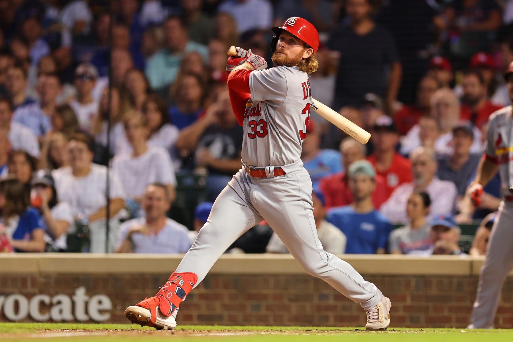 CHICAGO, ILLINOIS - AUGUST 24: Brendan Donovan #33 of the St. Louis Cardinals singles during the third inning against the Chicago Cubs at Wrigley Field on August 24, 2022 in Chicago, Illinois. (Photo by Michael Reaves/Getty Images)