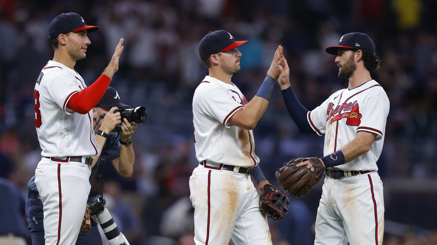 ATLANTA, GA - AUGUST 31: Matt Olson #28, Austin Riley #27 and Dansby Swanson #7 of the Atlanta Braves celebrate their 3-2 victory over the Colorado Rockies at Truist Park on August 31, 2022 in Atlanta, Georgia. (Photo by Todd Kirkland/Getty Images)
