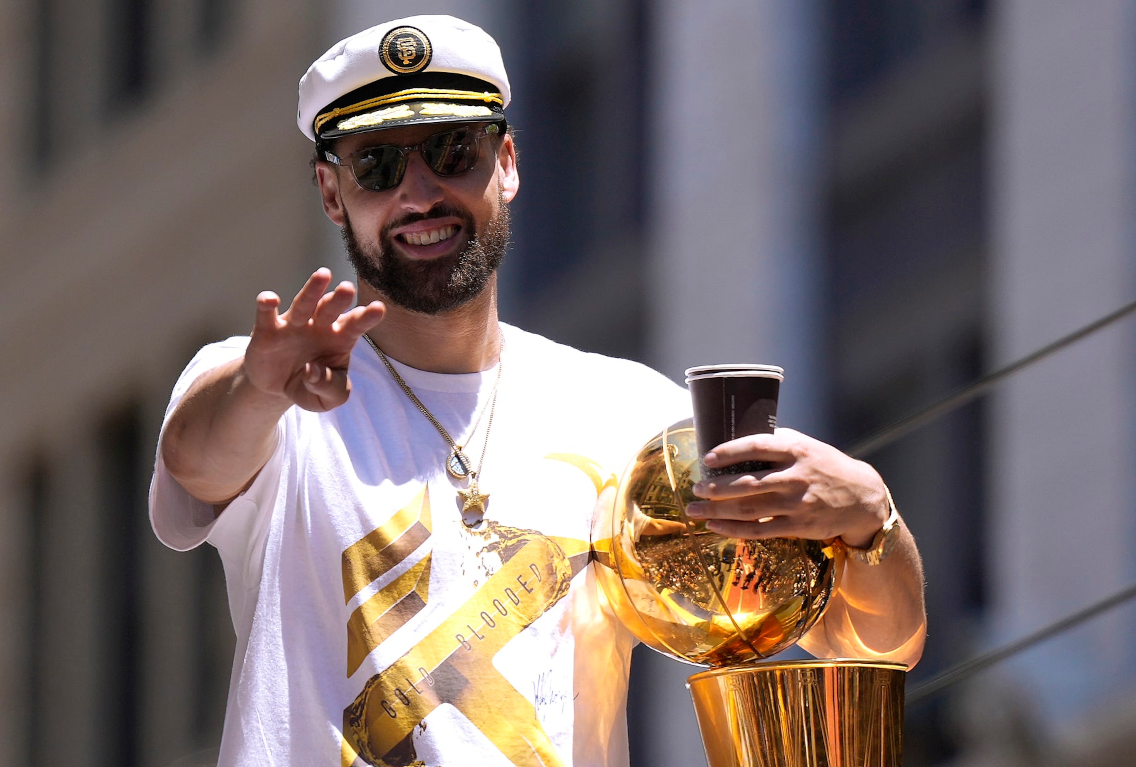 SAN FRANCISCO, CALIFORNIA - JUNE 20: Klay Thompson #11 of the Golden State Warriors celebrates with the NBA Championship Trophy during the Golden State Warriors Victory Parade on June 20, 2022 in San Francisco, California. The Golden State Warriors beat the Boston Celtics 4-2 to win the 2022 NBA Finals. NOTE TO USER: User expressly acknowledges and agrees that, by downloading and or using this photograph, User is consenting to the terms and conditions of the Getty Images License Agreement. (Photo by Thearon W. Henderson/Getty Images)(Photo by Thearon W. Henderson/Getty Images)