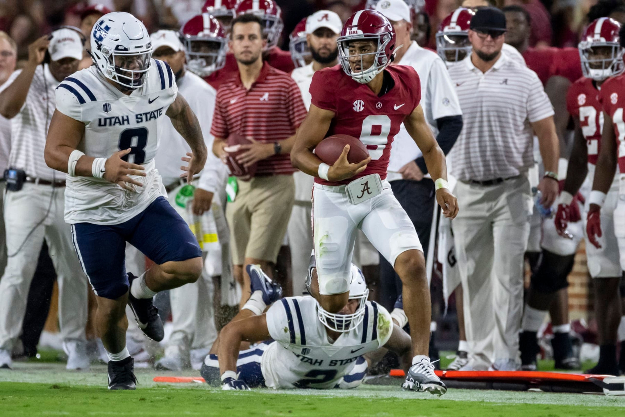 Alabama quarterback Bryce Young (9) runs past Utah State defensive lineman Hale Motu'apuaka (8) during the first half of an NCAA college football game, Saturday, Sept. 3, 2022, in Tuscaloosa, Ala. (AP Photo/Vasha Hunt) Alabama quarterback Bryce Young (9) runs past Utah State defensive lineman Hale Motu'apuaka (8) during the first half of an NCAA college football game, Saturday, Sept. 3, 2022, in Tuscaloosa, Ala. (AP Photo/Vasha Hunt)