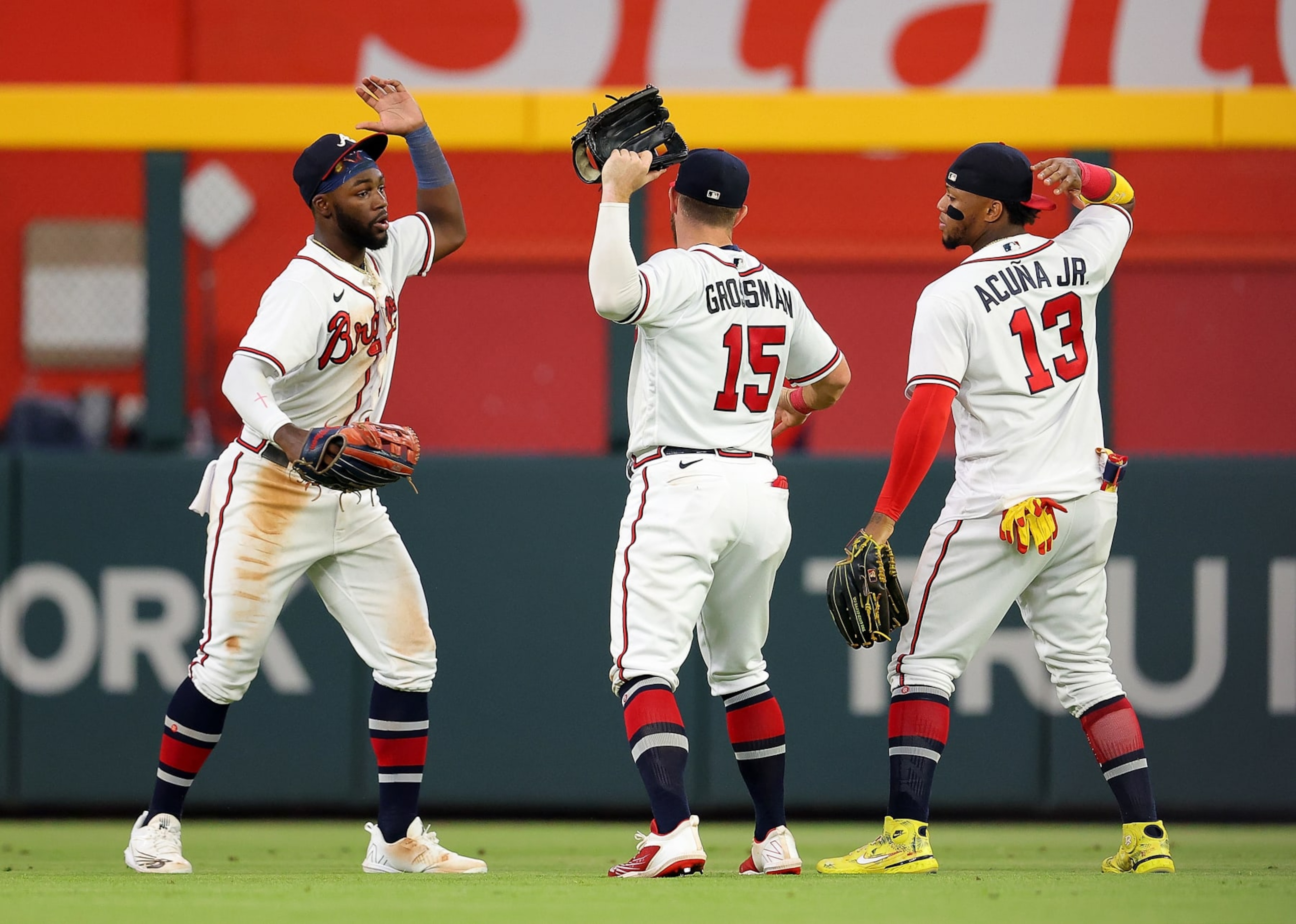 ATLANTA, GEORGIA - AUGUST 18: Michael Harris II #23, Robbie Grossman #15, and Ronald Acuna Jr. #13 of the Atlanta Braves react after their 3-2 win over the New York Mets at Truist Park on August 18, 2022 in Atlanta, Georgia. (Photo by Kevin C. Cox/Getty Images) ATLANTA, GEORGIA - AUGUST 18: Michael Harris II #23, Robbie Grossman #15, and Ronald Acuna Jr. #13 of the Atlanta Braves react after their 3-2 win over the New York Mets at Truist Park on August 18, 2022 in Atlanta, Georgia. (Photo by Kevin C. Cox/Getty Images)