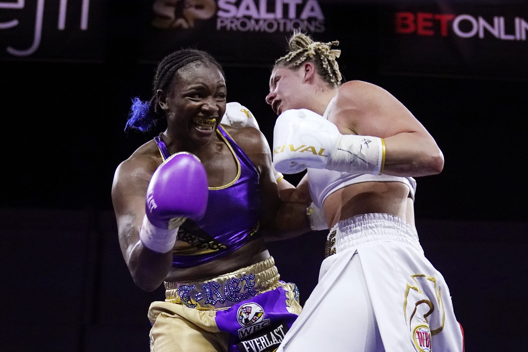 Marie-Eve Dicaire, right, tries to hit Claressa Shields with a right during the 10th round of a boxing bout for the women's super welterweight title Friday, March 5, 2021, in Flint, Mich. (AP Photo/Carlos Osorio)