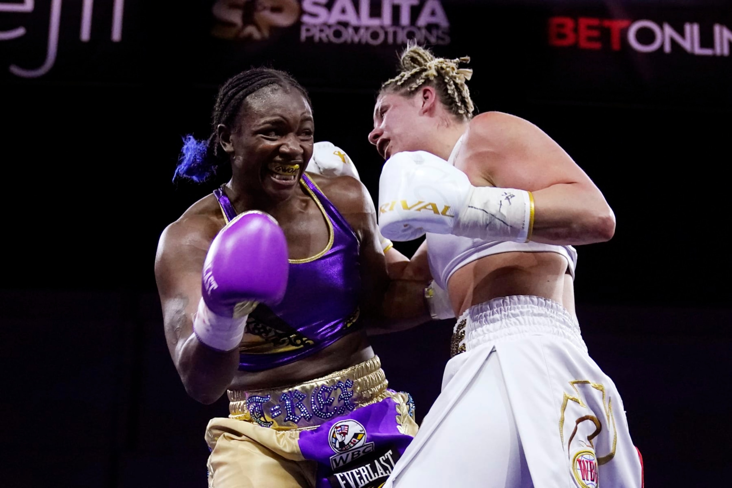 Marie-Eve Dicaire, right, tries to hit Claressa Shields with a right during the 10th round of a boxing bout for the women's super welterweight title Friday, March 5, 2021, in Flint, Mich. (AP Photo/Carlos Osorio)