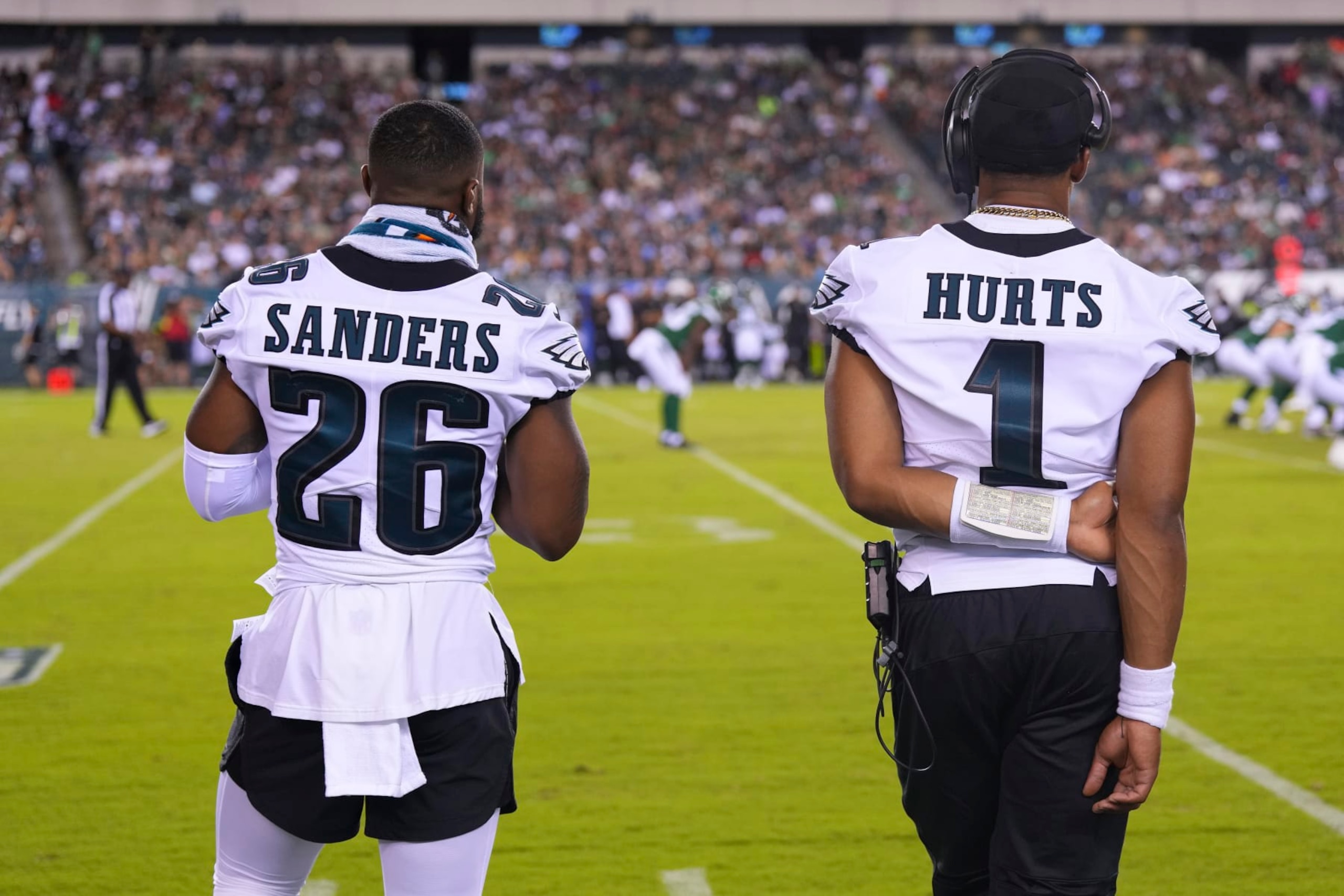 PHILADELPHIA, PA - AUGUST 12: Miles Sanders #26 and Jalen Hurts #1 of the Philadelphia Eagles look on from the sidelines against the New York Jets in the second half of the preseason game at Lincoln Financial Field on August 12, 2022 in Philadelphia, Pennsylvania. The Jets defeated the Eagles 24-21. (Photo by Mitchell Leff/Getty Images)