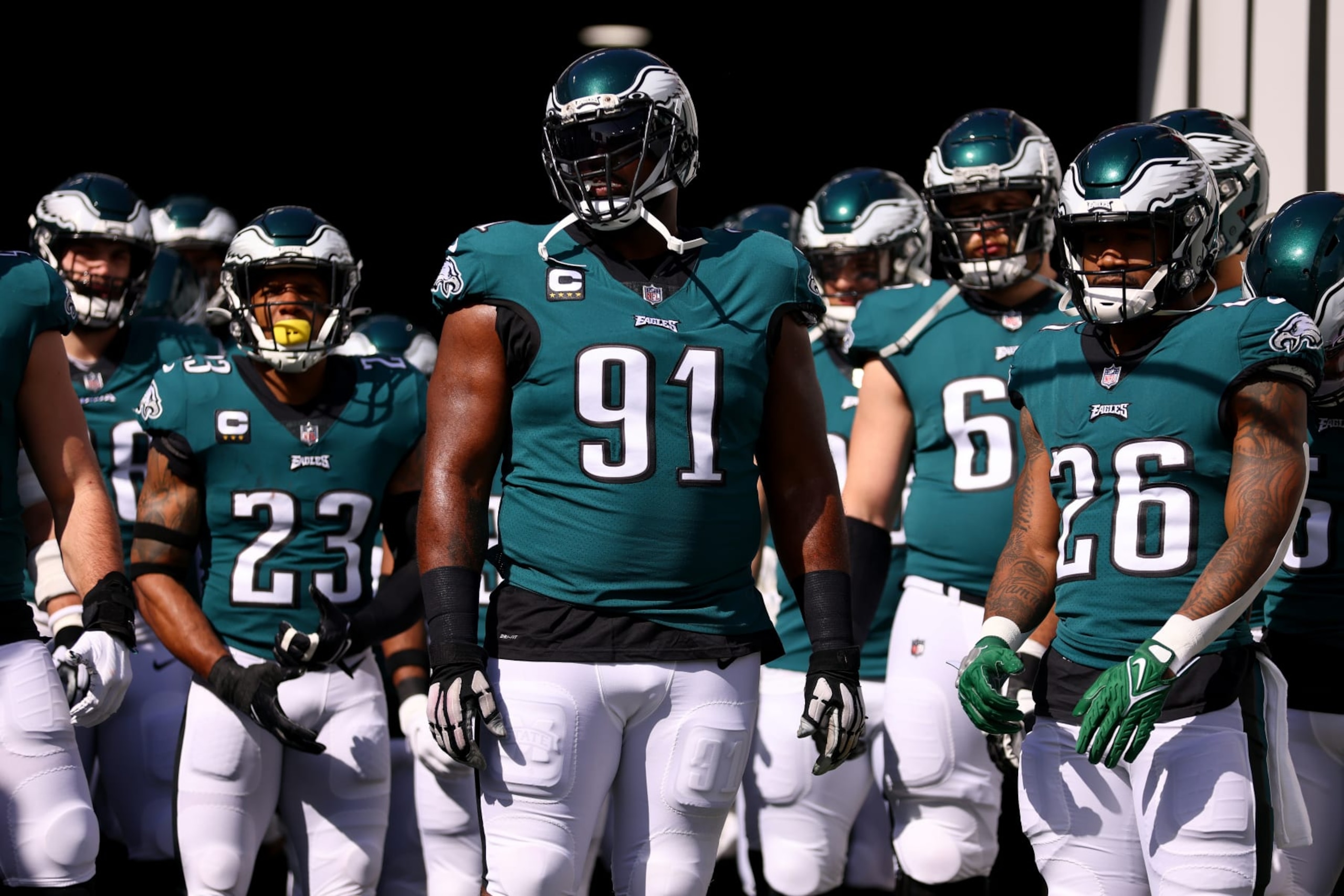 TAMPA, FLORIDA - JANUARY 16: Fletcher Cox #91 and Miles Sanders #26 of the Philadelphia Eagles wait to take the field with their teammates prior to the NFC Wild Card Playoff game against the Tampa Bay Buccaneers at Raymond James Stadium on January 16, 2022 in Tampa, Florida. (Photo by Michael Reaves/Getty Images)