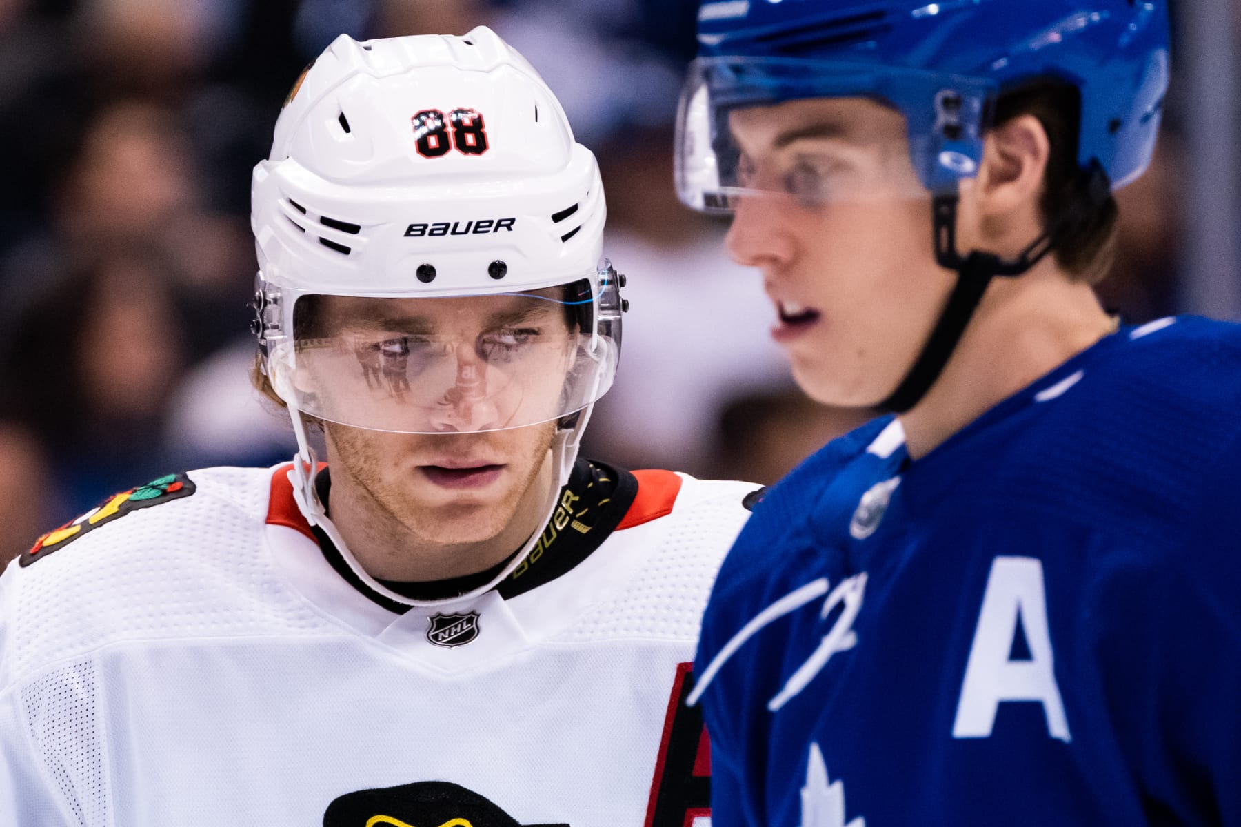 TORONTO, ON - JANUARY 18: Patrick Kane #88 of the Chicago Blackhawks looks on as Mitchell Marner #16 of the Toronto Maple Leafs passes by during the first period at the Scotiabank Arena on January 18, 2020 in Toronto, Ontario, Canada. (Photo by Kevin Sousa/NHLI via Getty Images)