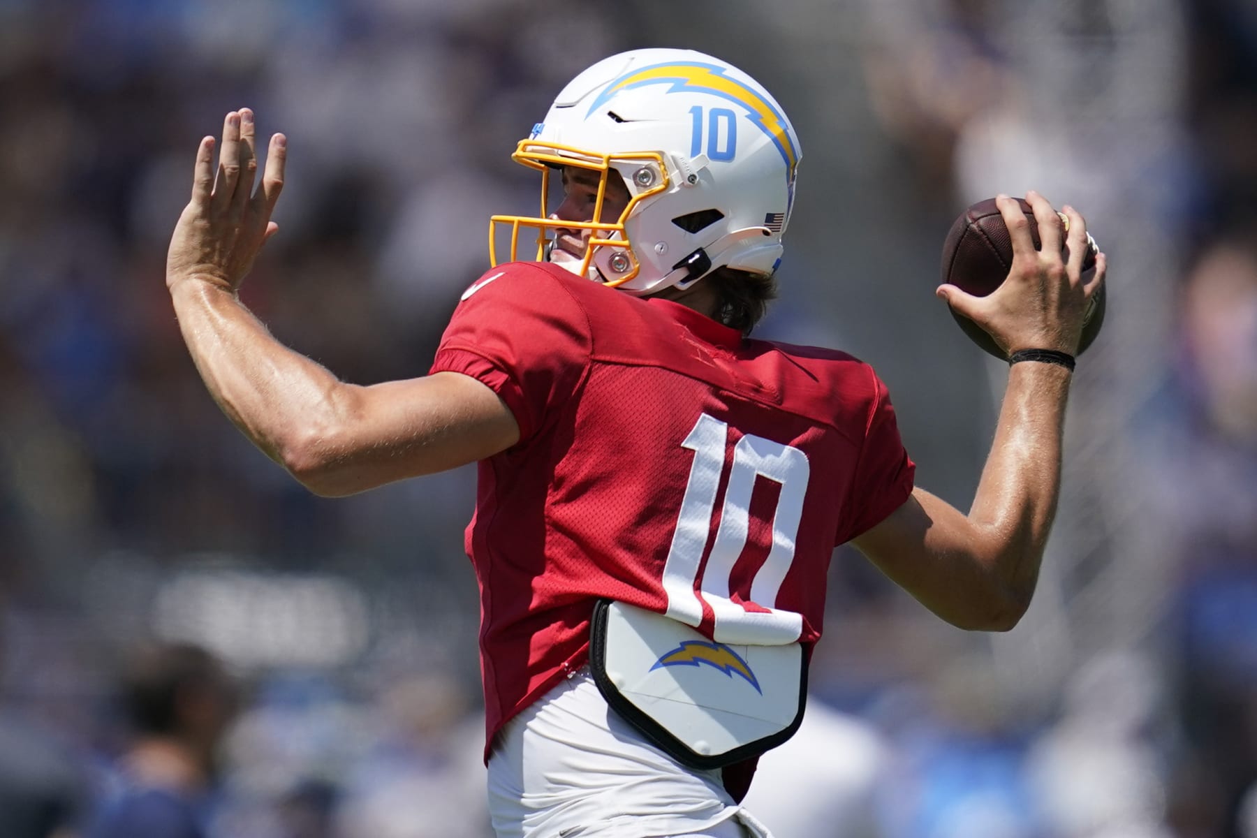 Los Angeles Chargers quarterback Justin Herbert (10) participates in drills during a combined NFL practice with the Dallas Cowboys at the Los Angeles Rams' practice facility in Costa Mesa, Calif. Wednesday, Aug. 17, 2022. (AP Photo/Ashley Landis)