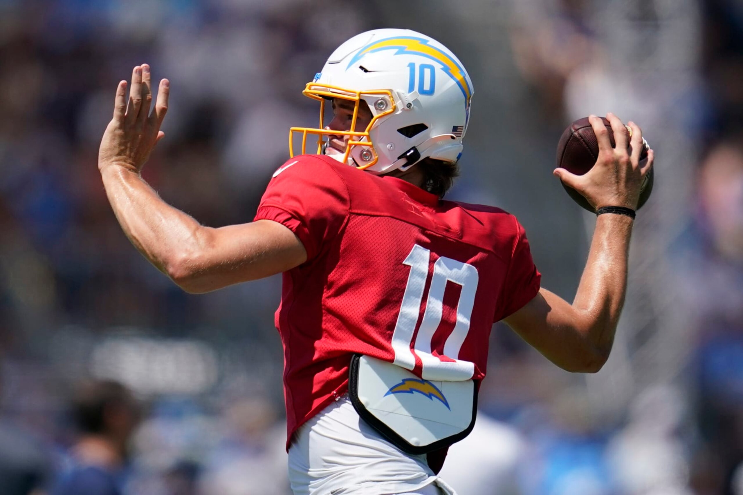 Los Angeles Chargers quarterback Justin Herbert (10) participates in drills during a combined NFL practice with the Dallas Cowboys at the Los Angeles Rams' practice facility in Costa Mesa, Calif. Wednesday, Aug. 17, 2022. (AP Photo/Ashley Landis)