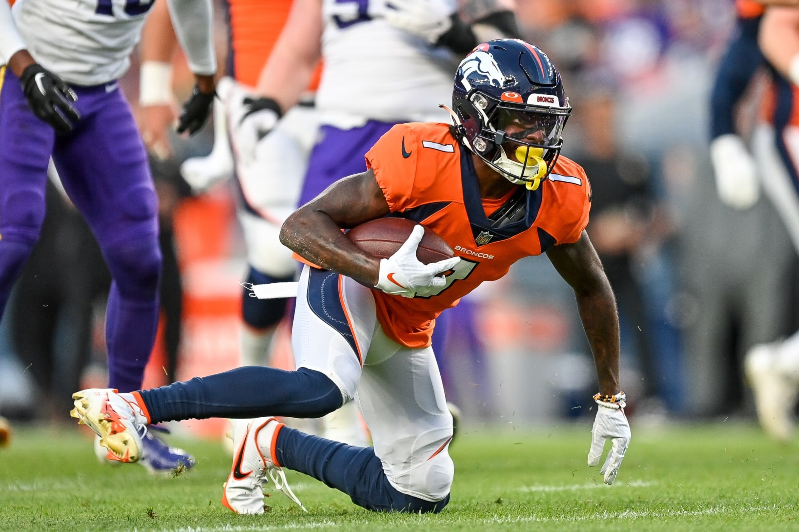 DENVER, COLORADO - AUGUST 27:  Wide receiver KJ Hamler #1 of the Denver Broncos stands up after a catch against the Minnesota Vikings during a preseason NFL game at Empower Field at Mile High on August 27, 2022 in Denver, Colorado. (Photo by Dustin Bradford/Getty Images)