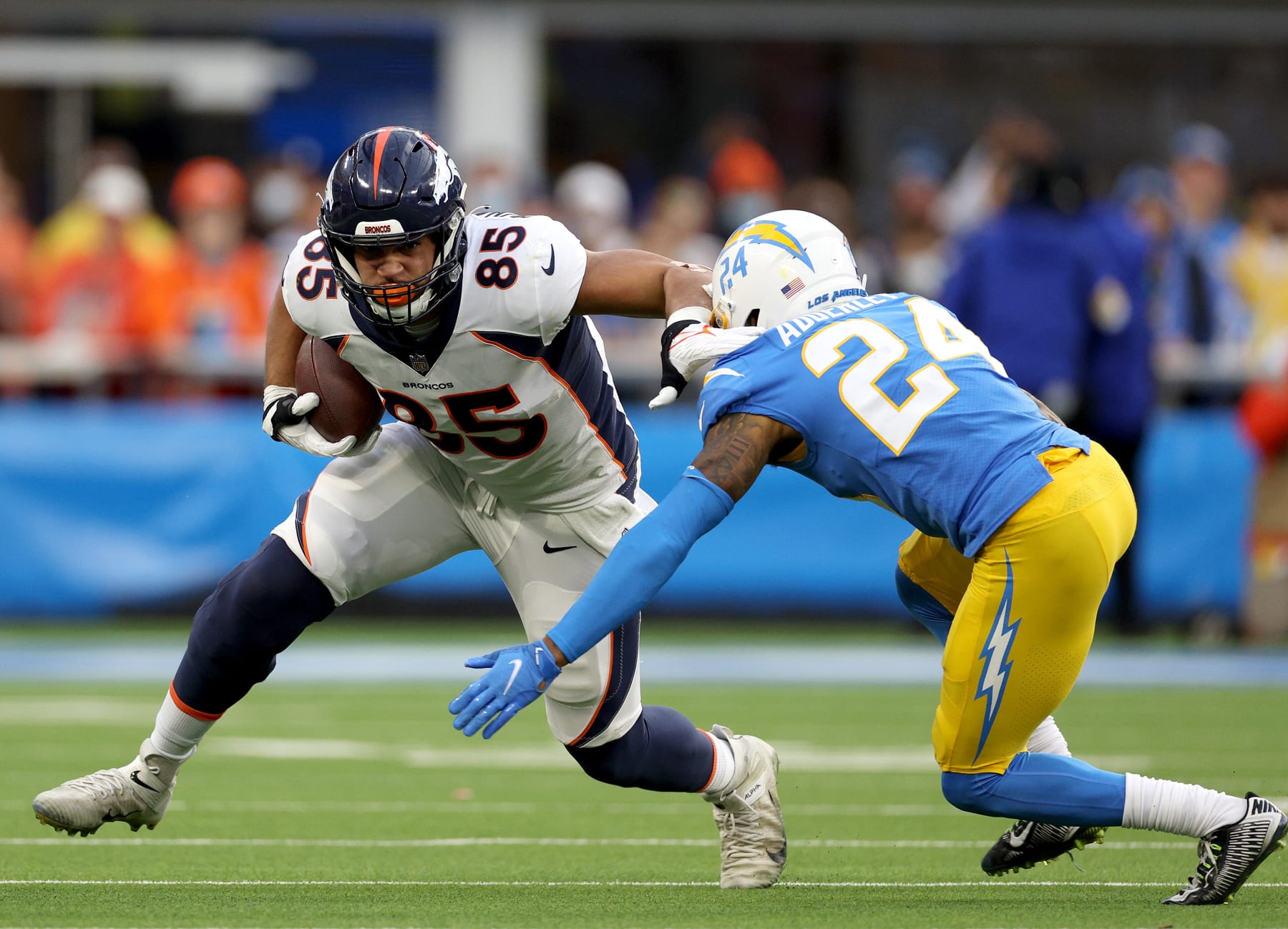 INGLEWOOD, CALIFORNIA - JANUARY 02: Albert Okwuegbunam #85 of the Denver Broncos is met by Nasir Adderley #24 of the Los Angeles Chargers after his catch during a 34-13 loss to the Chargers at SoFi Stadium on January 02, 2022 in Inglewood, California. (Photo by Harry How/Getty Images)