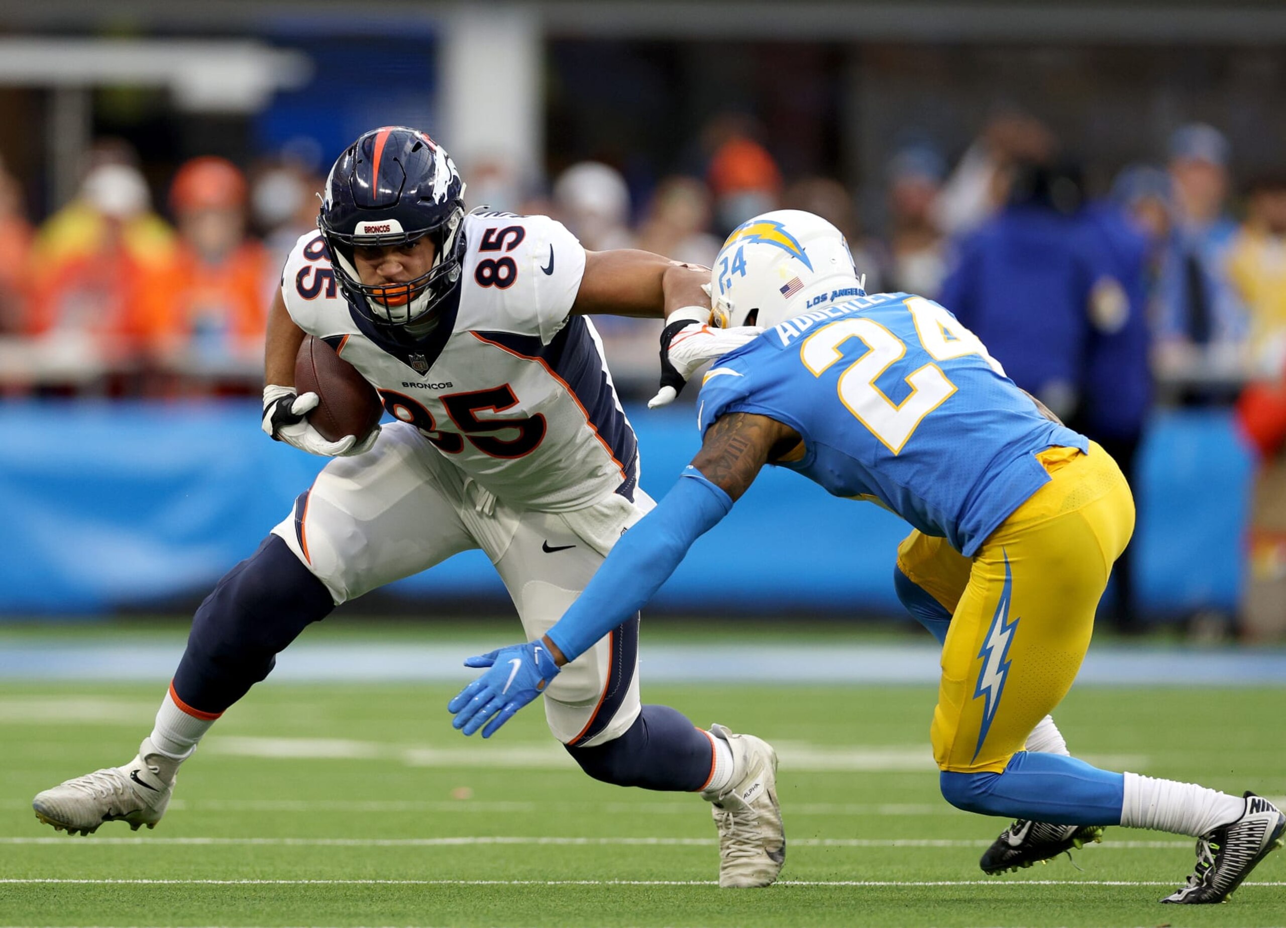 INGLEWOOD, CALIFORNIA - JANUARY 02: Albert Okwuegbunam #85 of the Denver Broncos is met by Nasir Adderley #24 of the Los Angeles Chargers after his catch during a 34-13 loss to the Chargers at SoFi Stadium on January 02, 2022 in Inglewood, California. (Photo by Harry How/Getty Images)