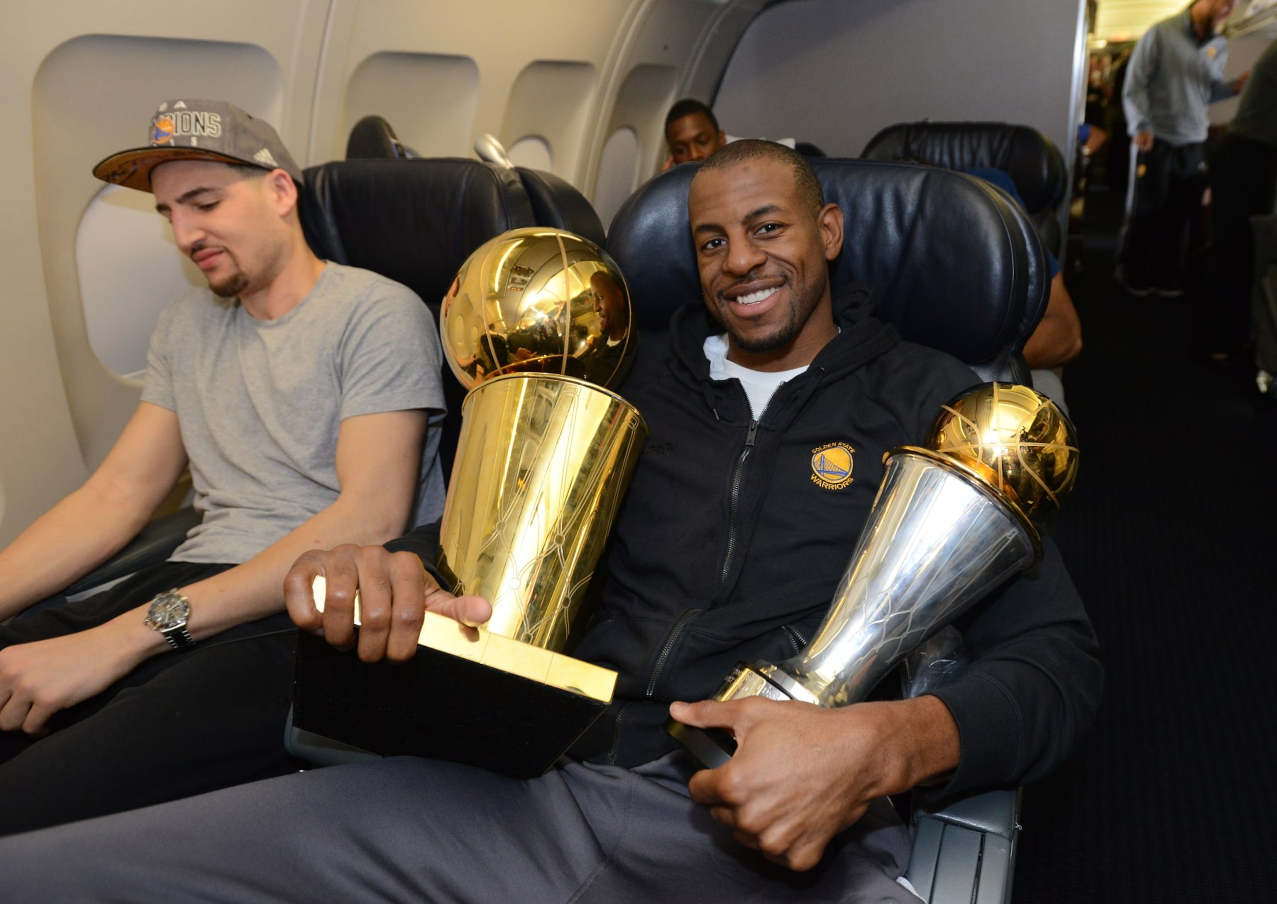 OAKLAND, CA - JUNE 17:  Andre Iguodala #9 of the Golden State Warriors holds the NBA and MVP trophy on the plane as the team travels home from Cleveland after winning the 2015 NBA Finals on June 17, 2015 in Oakland, California. NOTE TO USER: User expressly acknowledges and agrees that, by downloading and/or using this Photograph, user is consenting to the terms and conditions of the Getty Images License Agreement. Mandatory Copyright Notice: Copyright 2015 NBAE (Photo by Noah Graham/NBAE via Getty Images)