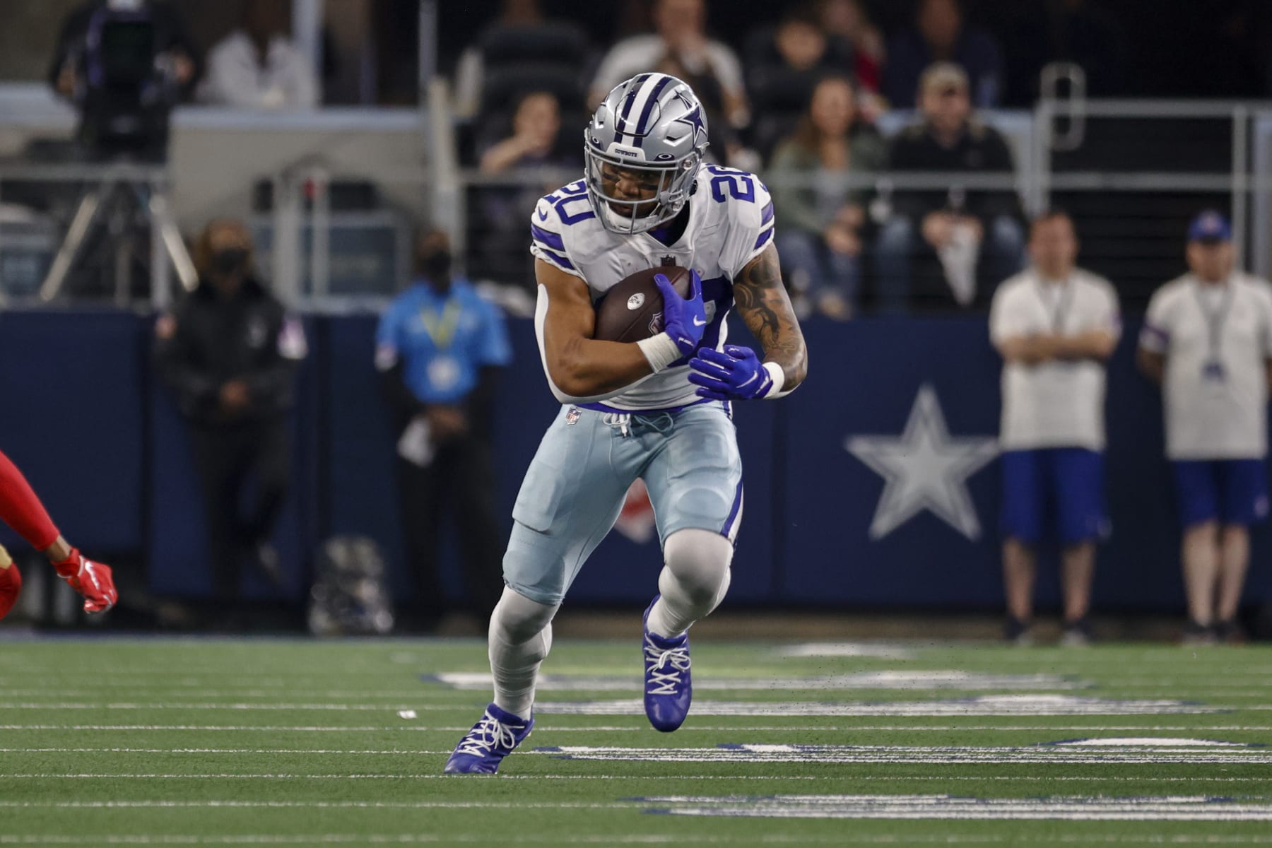 ARLINGTON, TX - JANUARY 16: Dallas Cowboys running back Tony Pollard (20) runs for a first down during the NFC Wild Card game between the Dallas Cowboys and the San Francisco 49ers on January 16, 2022 at AT&T Stadium in Arlington, Texas. (Photo by Matthew Pearce/Icon Sportswire via Getty Images)