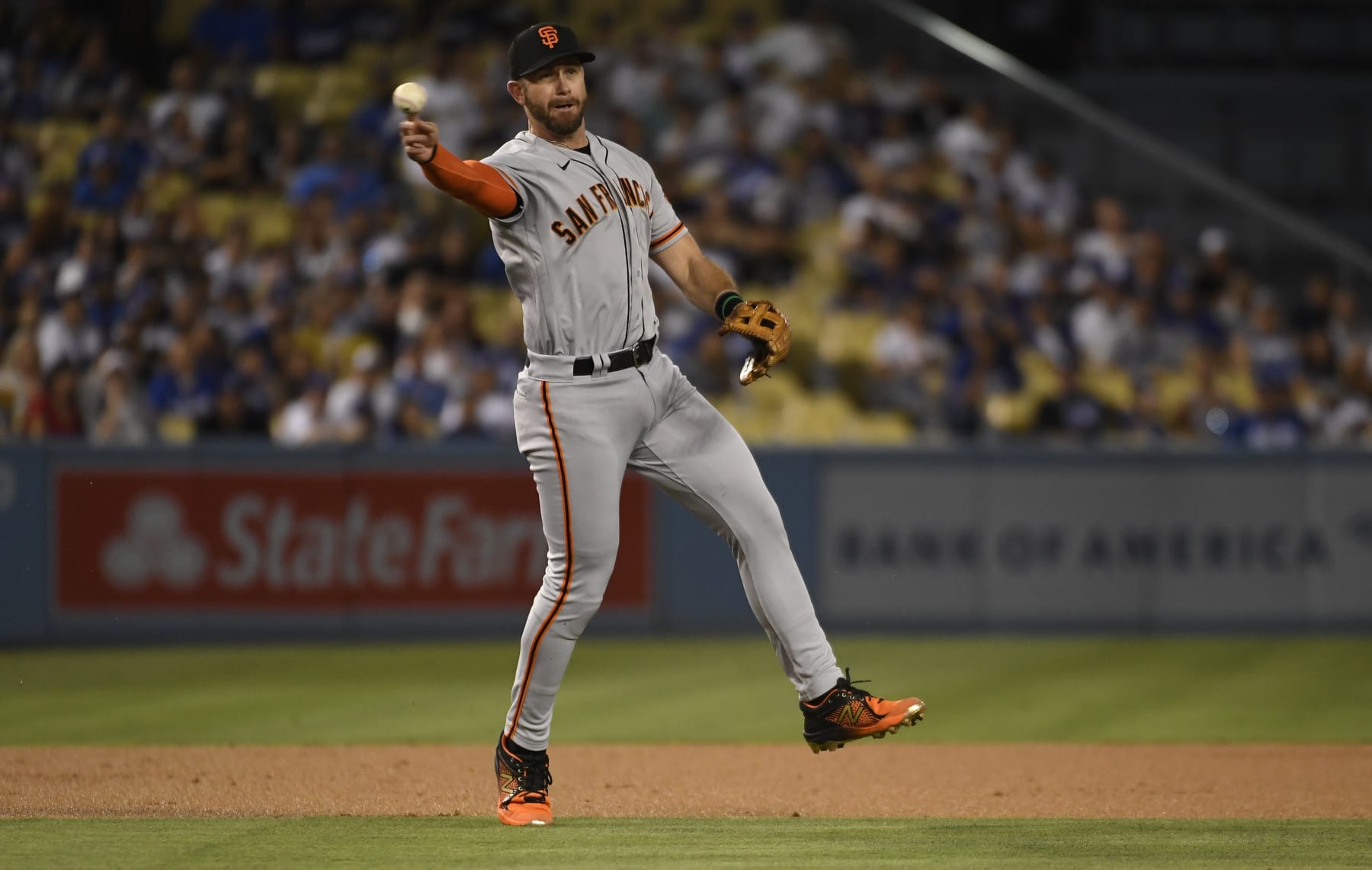 LOS ANGELES, CA - SEPTEMBER 05: Third baseman Evan Longoria #10 of the San Francisco Giants throws erroneously to first base in an attempt to get lead off batter Mookie Betts #50 Los Angeles Dodgers during the first inning at Dodger Stadium on September 5, 2022 in Los Angeles, California. (Photo by Kevork Djansezian/Getty Images)