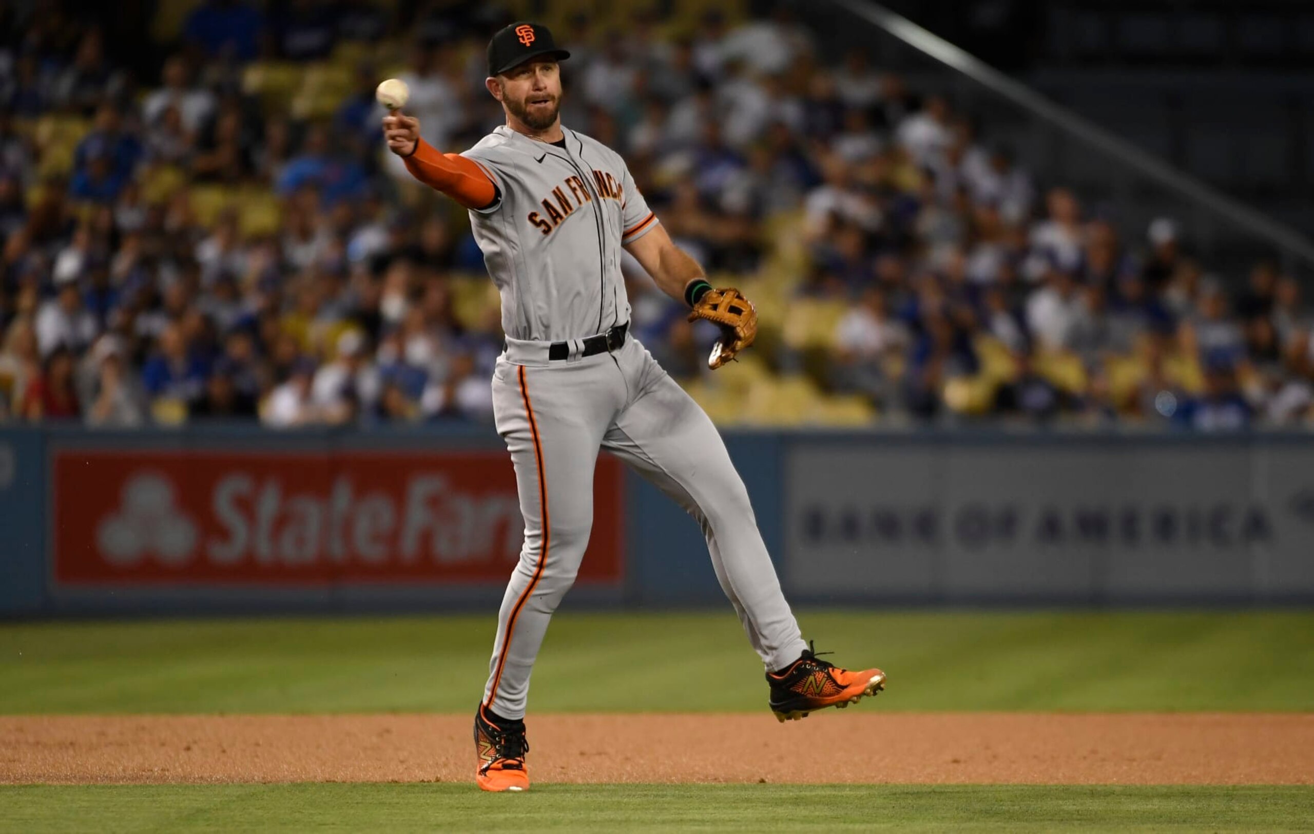 LOS ANGELES, CA - SEPTEMBER 05: Third baseman Evan Longoria #10 of the San Francisco Giants throws erroneously to first base in an attempt to get lead off batter Mookie Betts #50 Los Angeles Dodgers during the first inning at Dodger Stadium on September 5, 2022 in Los Angeles, California. (Photo by Kevork Djansezian/Getty Images)