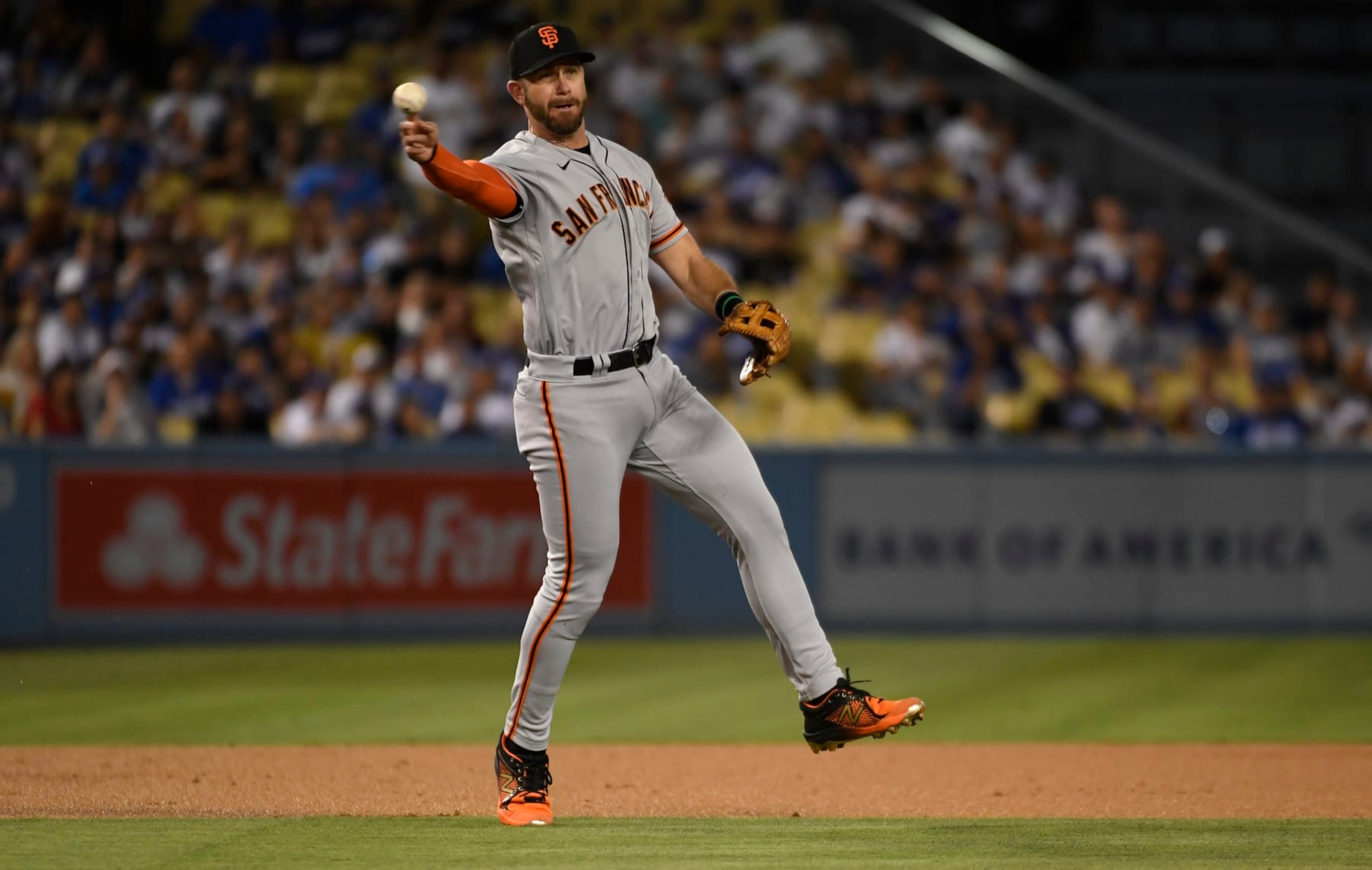 LOS ANGELES, CA - SEPTEMBER 05: Third baseman Evan Longoria #10 of the San Francisco Giants throws erroneously to first base in an attempt to get lead off batter Mookie Betts #50 Los Angeles Dodgers during the first inning at Dodger Stadium on September 5, 2022 in Los Angeles, California. (Photo by Kevork Djansezian/Getty Images)