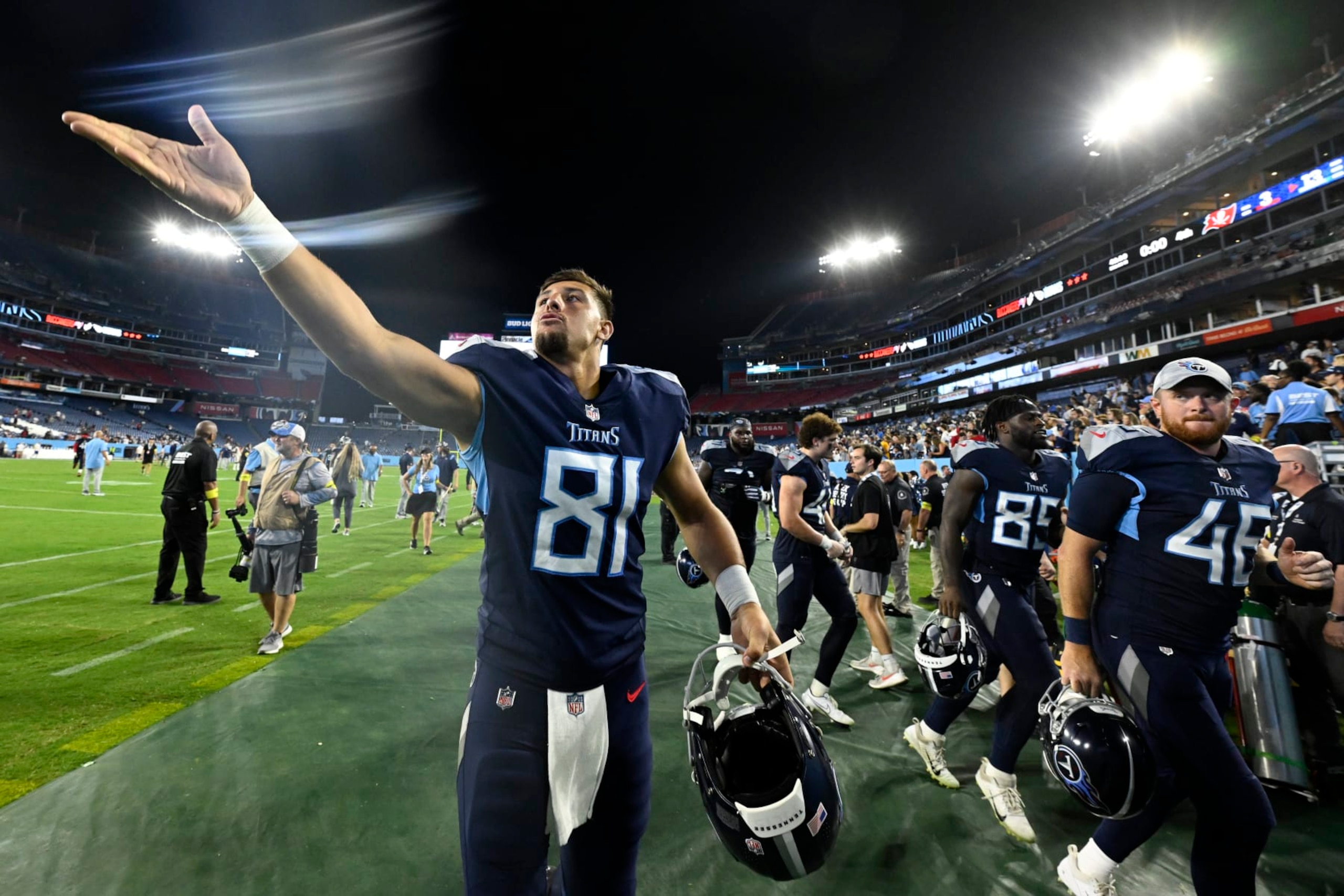Tennessee Titans tight end Austin Hooper (81) tosses an item to a fan after a preseason NFL football game against the Tampa Bay Buccaneers Saturday, Aug. 20, 2022, in Nashville, Tenn. (AP Photo/John Amis)