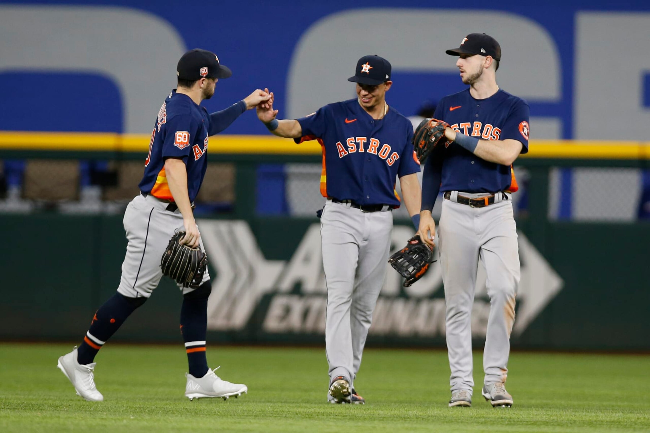ARLINGTON, TEXAS - AUGUST 30: Chas McCormick #20 of the Houston Astros, Mauricio Dubon #14 and Kyle Tucker #30 celebrate after victory over the Texas Rangers at Globe Life Field on August 30, 2022 in Arlington, Texas. (Photo by Tim Heitman/Getty Images)