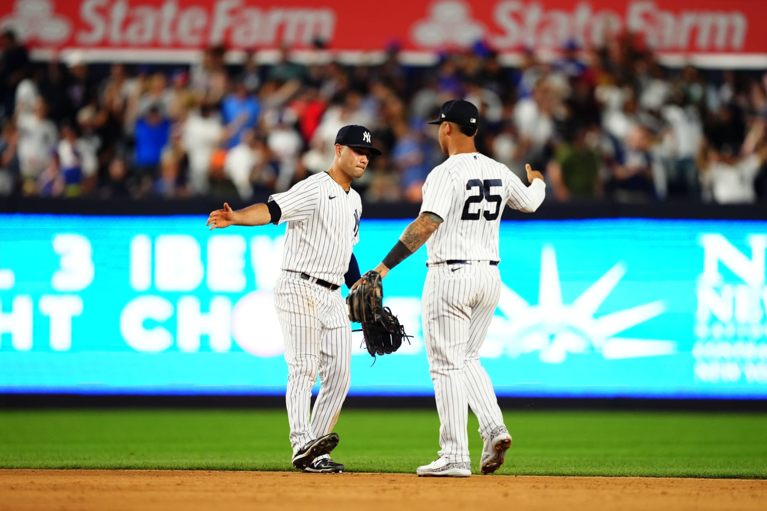 NEW YORK, NY - AUGUST 23: Gleyber Torres #25 and Isiah Kiner-Falefa #12 of the New York Yankees celebrate their win over the New York Mets at Yankee Stadium on Tuesday, August 23, 2022 in New York, New York. (Photo by Daniel Shirey/MLB Photos via Getty Images)
